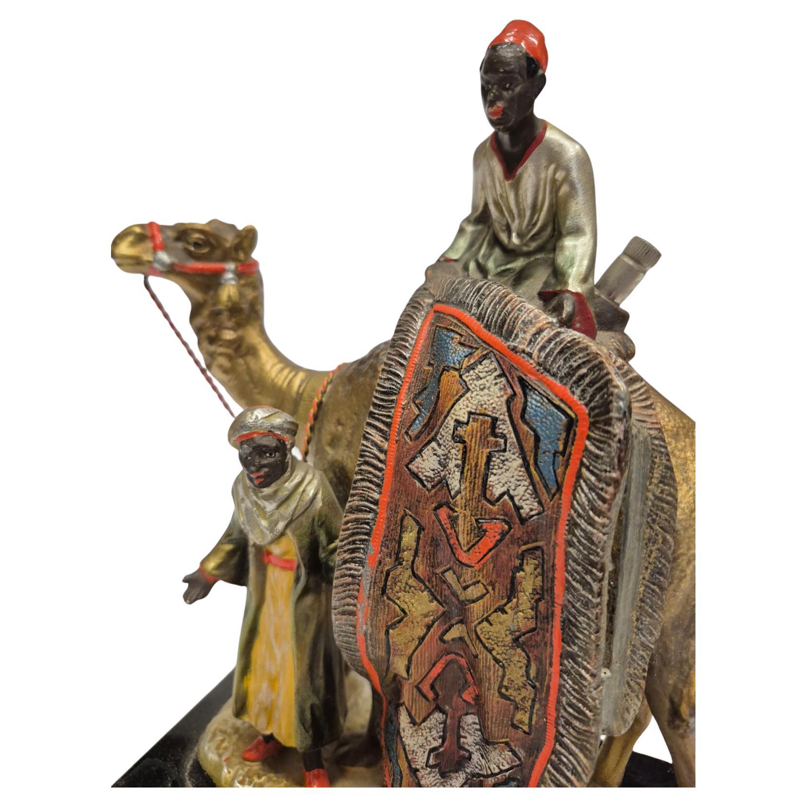 Antique Viennese table lighter made of cold-painted bronze with carpet seller and camel around 1930, good condition