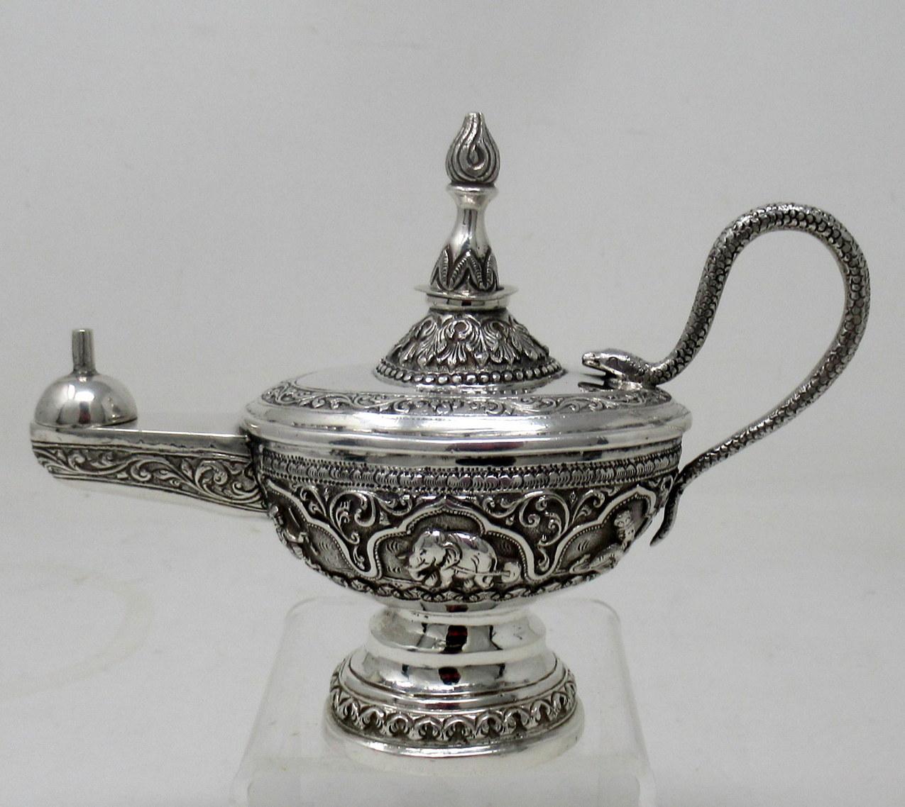 An exceptionally fine example of a solid silver Anglo Indian Gentlemans Cigar Lighter of traditional form and generous heavy gauge weight. Circa third quarter of the Nineteenth Century. 

The main oval body with applied scroll handle modelled as a