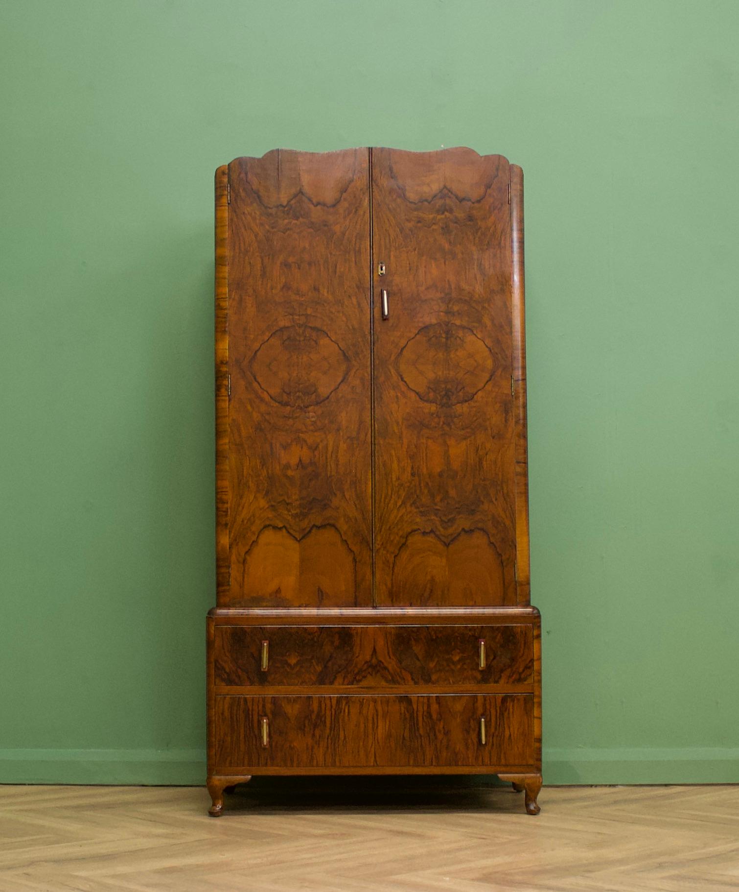 An impressive quality, 1930's burr walnut compact wardrobe - perfect for a maximalist interior
Featuring a pull out rail to the top and two drawers to the bottom