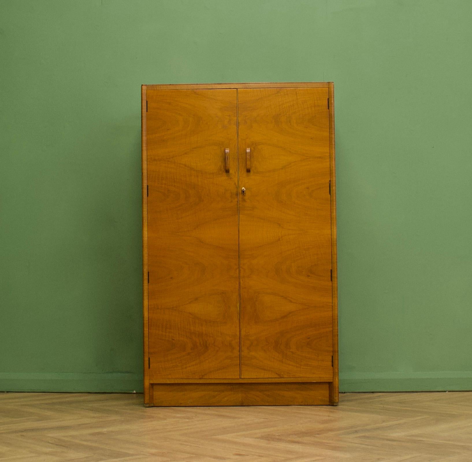 An impressive quality, 1930's burr walnut compact wardrobe
Featuring a pull out rail to the top and shelves