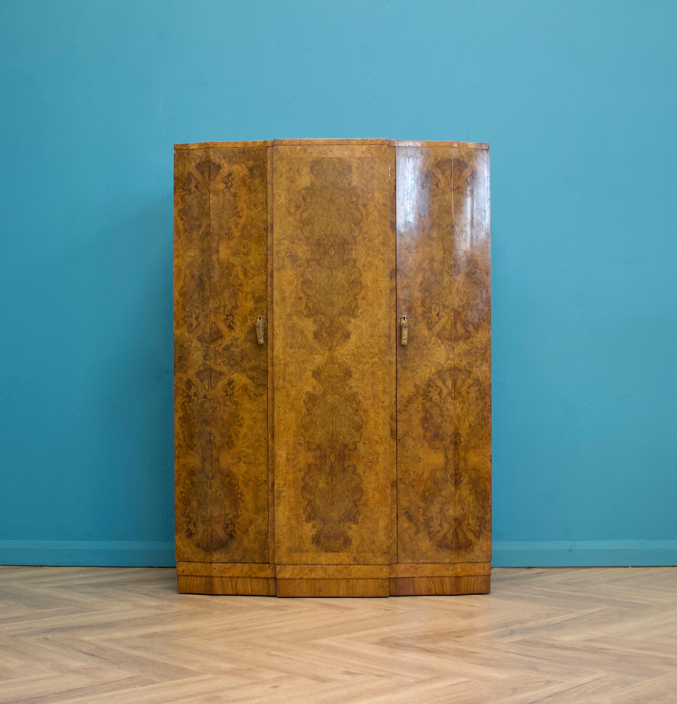 An impressive quality, Art Deco 1930's burr walnut compact wardrobe
Featuring a rail to one side, shelves and drawers to the other
The handles inside and out are chased silvered
