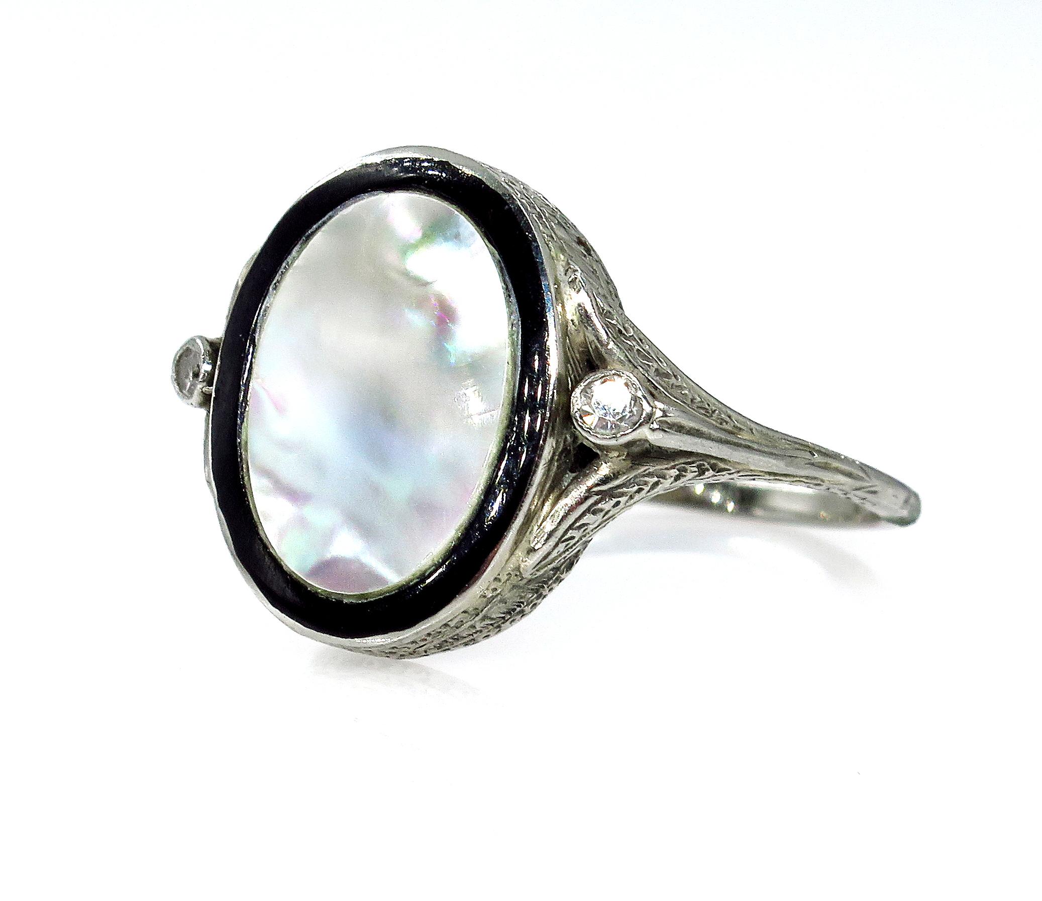 A truly spectacular and Fun Jazz Age jewel that will take you from Day to Night. From the Roaring '20s comes this striking Black & White Mother -of-Pearl Ring. Elegantly hand-fabricated in platinum, hand-engraved designs surround the loveliest