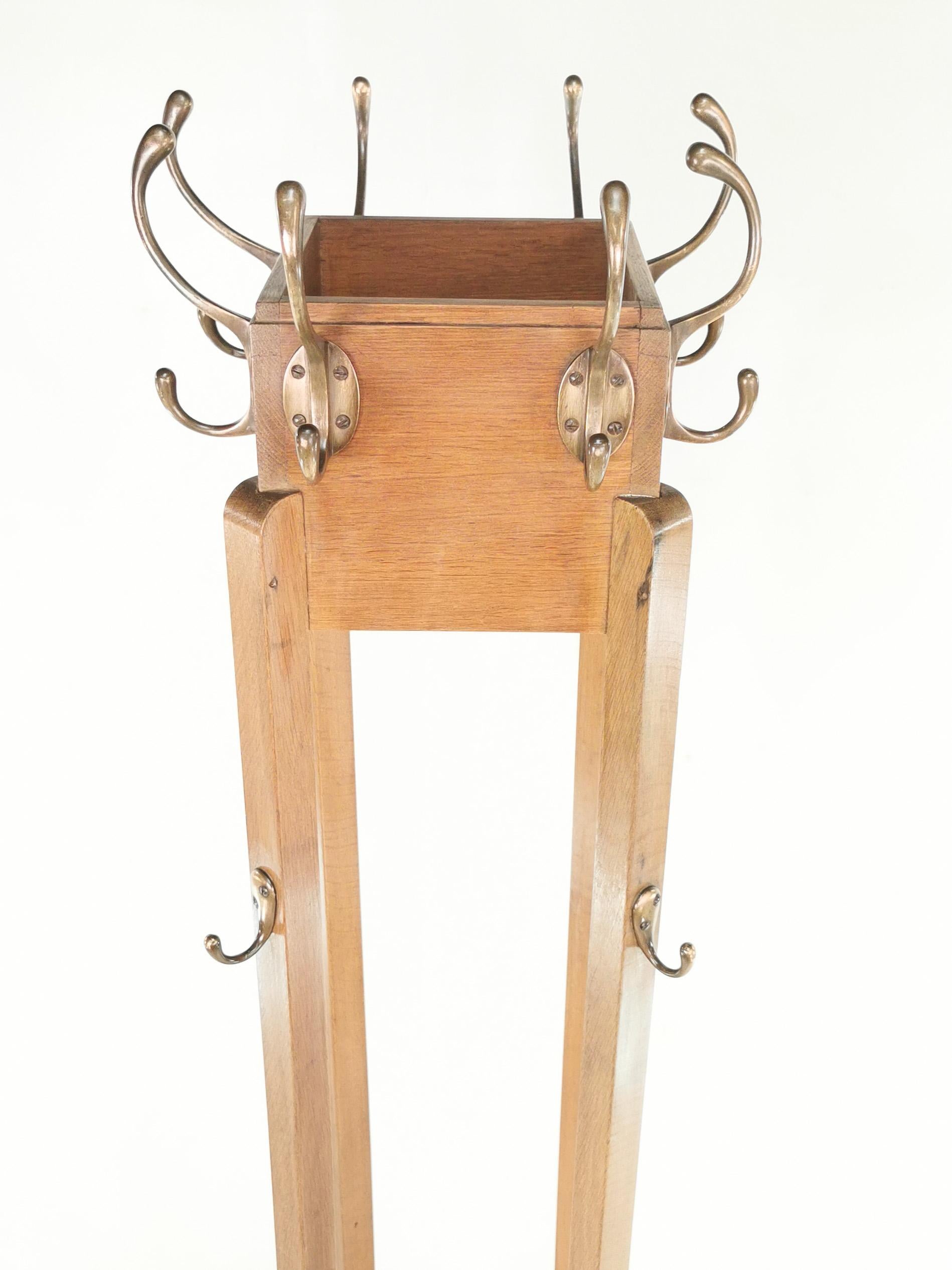 Art Deco coat stand 

A British made art deco solid oak coat stand with superb line from that era. Circa 1940.

Eight upper hooks, and four lower hooks for hats and coats. 

Dimensions (cm): 

197 H x 58 W x 58 D

Condition: 

The coat