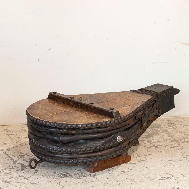 This highly unusual coffee table is a great conversation piece since it is made from an original antique blacksmith's bellows. It has been placed on three feet so is stable, strong and level, ready for daily use. If you are looking for a one of a