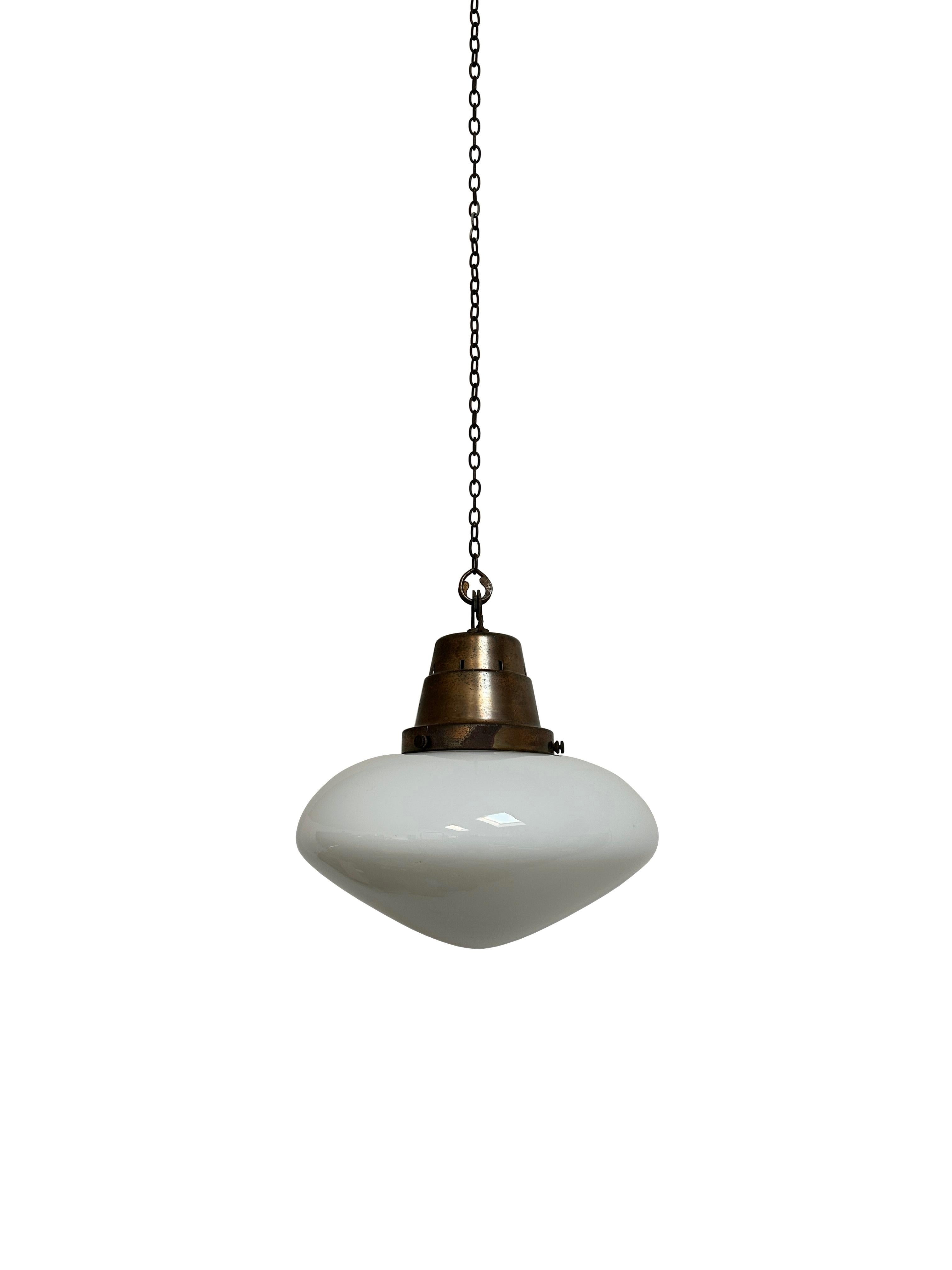 - An oval lid opaline glass pendant light with stepped copper gallery, circa 1930.
- Incredible eye catching shape with beautiful white opaline glass, wear commensurate with age, all in good condition.
- Rewired with dark brown braided flex and