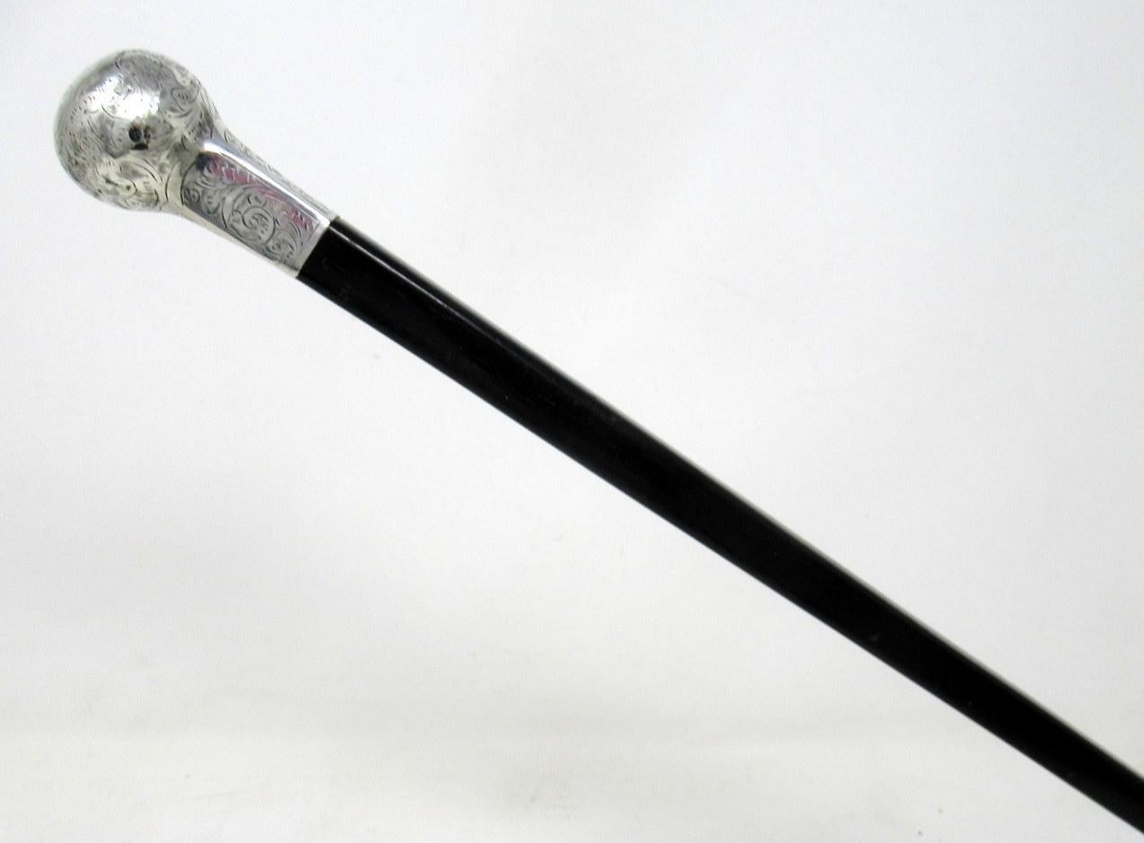 A very stylish polished ebonized walking cane stick with unusual shaft of square tapering form and of outstanding quality with embossed silver grip handle, early 20th century.

The embossed silver knopped grip above a tapering ebony shaft with