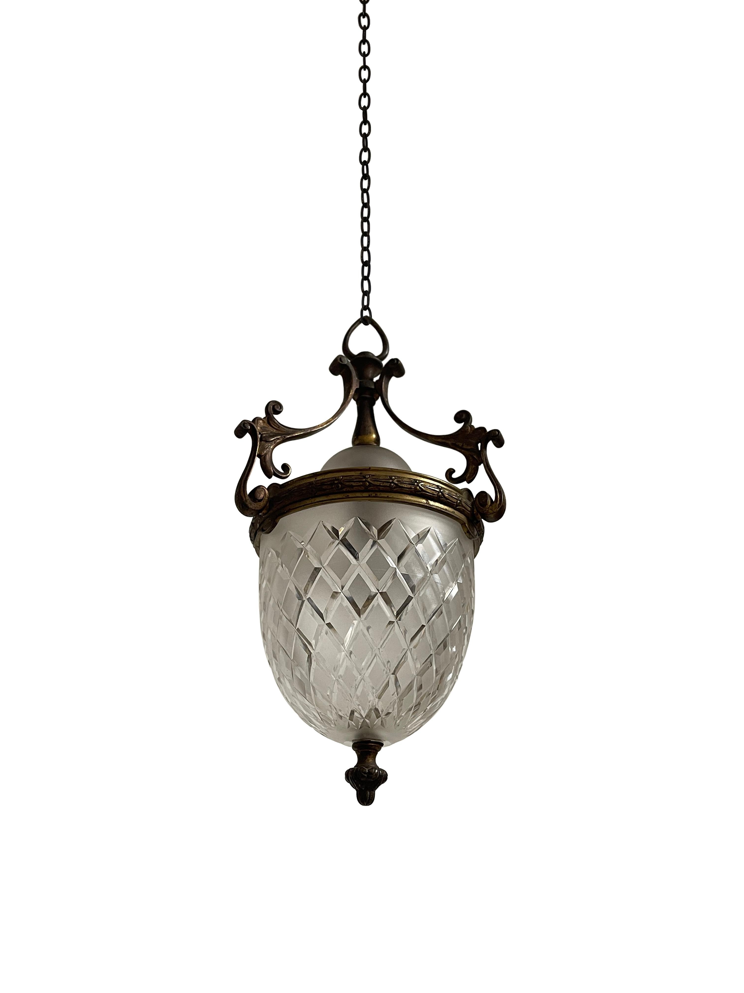 - An elegant cut glass ceiling pendant with original decorative brass gallery, English circa 1910.
- The cut glass shade is clear, heavy and of quality, an opaque glass dish sits across the top illuminating space with a soft, warm glow.
- Wear