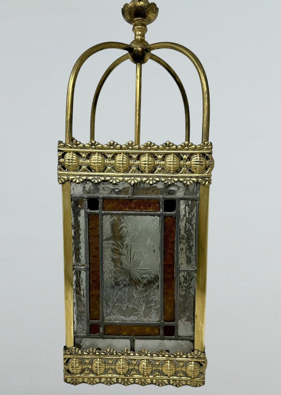 Stunning Traditional Style-Stained Glass English Single Bulb Ceiling Lantern of square outline and outstanding quality. Late Nineteenth, early Twentieth Century, Edwardian period. 

The ornate polished brass frame enclosing four identical exquisite
