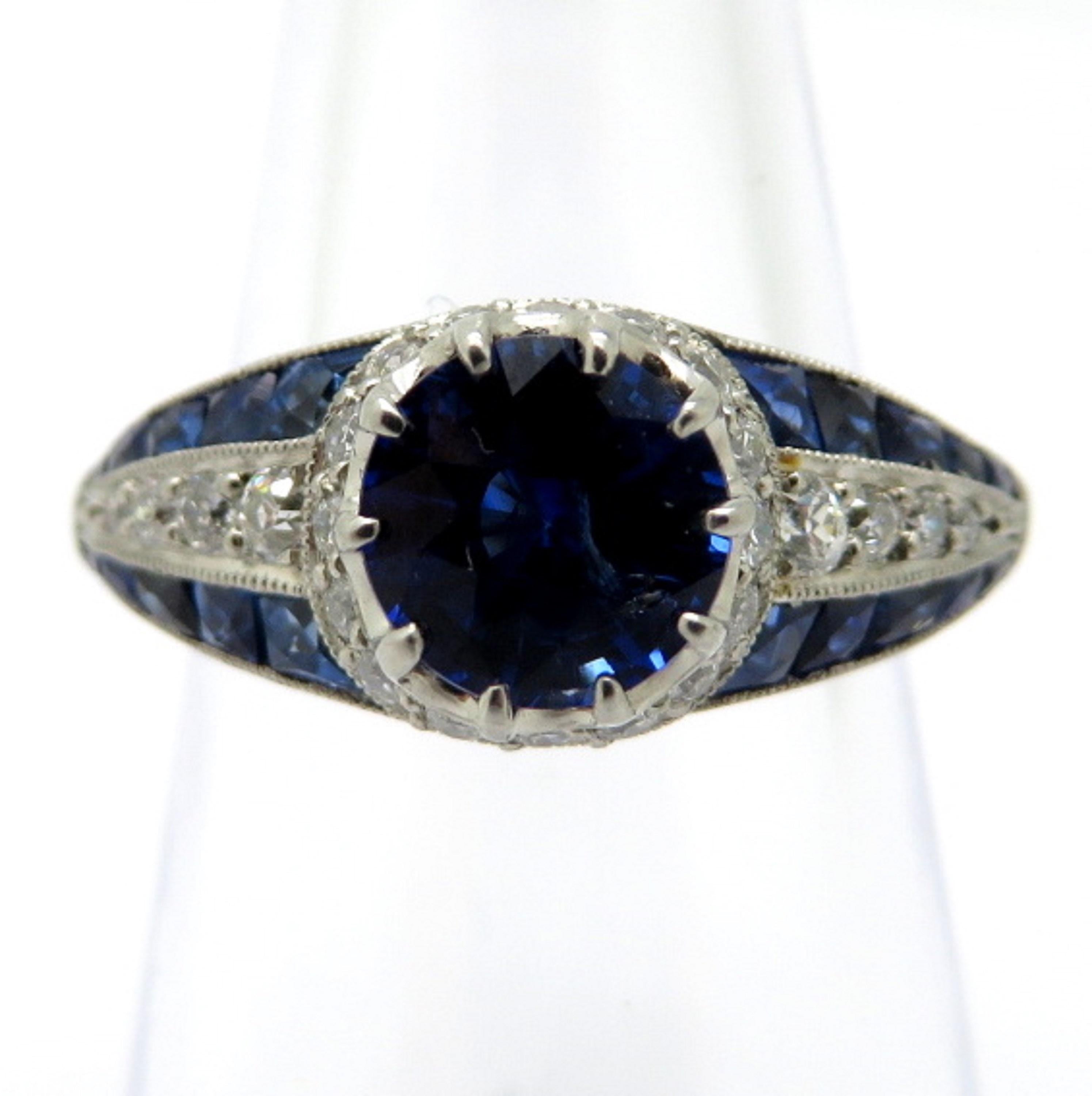 For sale is a stunning estate Platinum Diamond and Sapphire Art Deco ring!
Showcasing one (1) Round Brilliant Cut natural fine quality blue sapphire, measuring 6.61-6.64 mm, weighing approximately 1.34 carats.  
Accenting the sapphire are forty-two