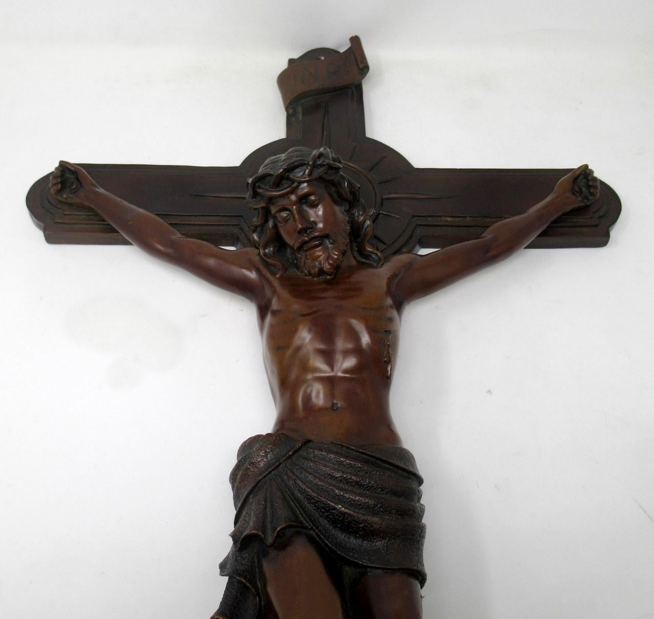 An exceptionally fine quality example of a well cast patinated dark bronze figure depicting Jesus Christ nailed to a cast metal bronzed hanging cross of impressive proportions, late 19th-early 20th century, of French or English