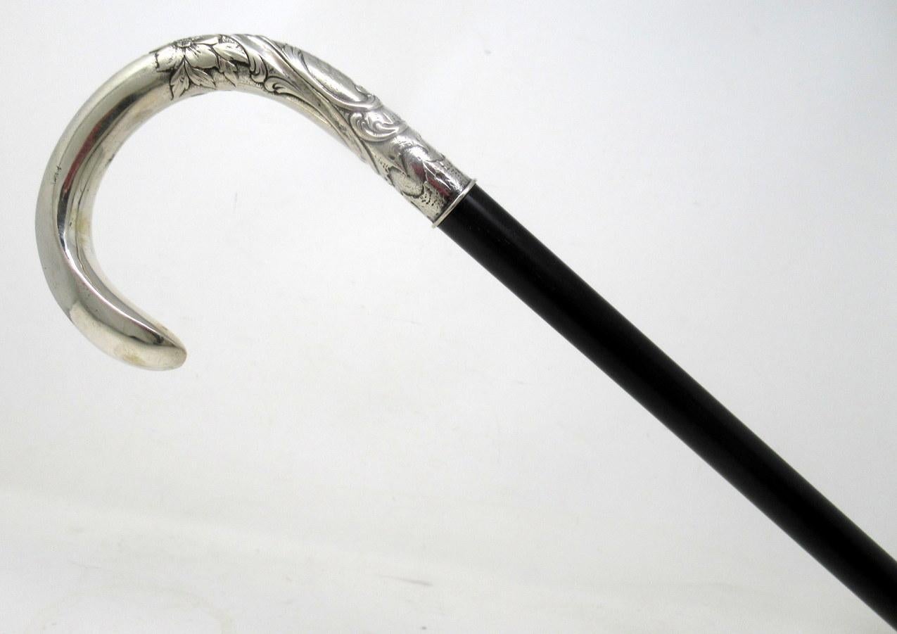 Stylish solid polished ebony and sterling silver lady’s or gentleman’s walking stick with traditional ornately cast Crook shaped handle, of French origin, complete with a professionally turned silver heavy gauge ferrule, later added.  

The