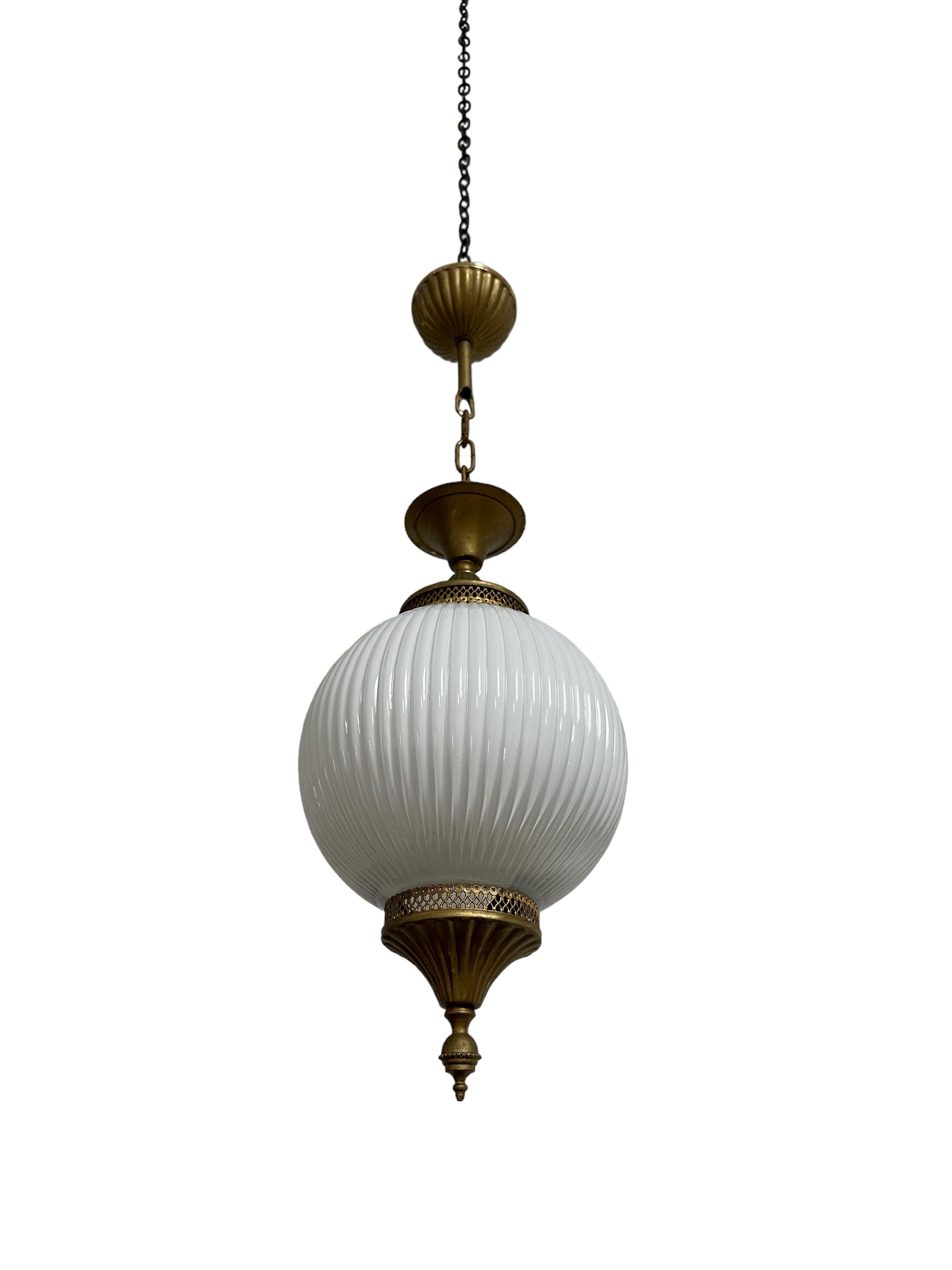 - A beautiful and rare satin opaline ceiling pendant, France circa 1930.
- Wonderful ribbed detail across the opaline globe and intricate decorative brass gallery and finial above and beneath the glass, original ceiling rose also included.
- Rewired