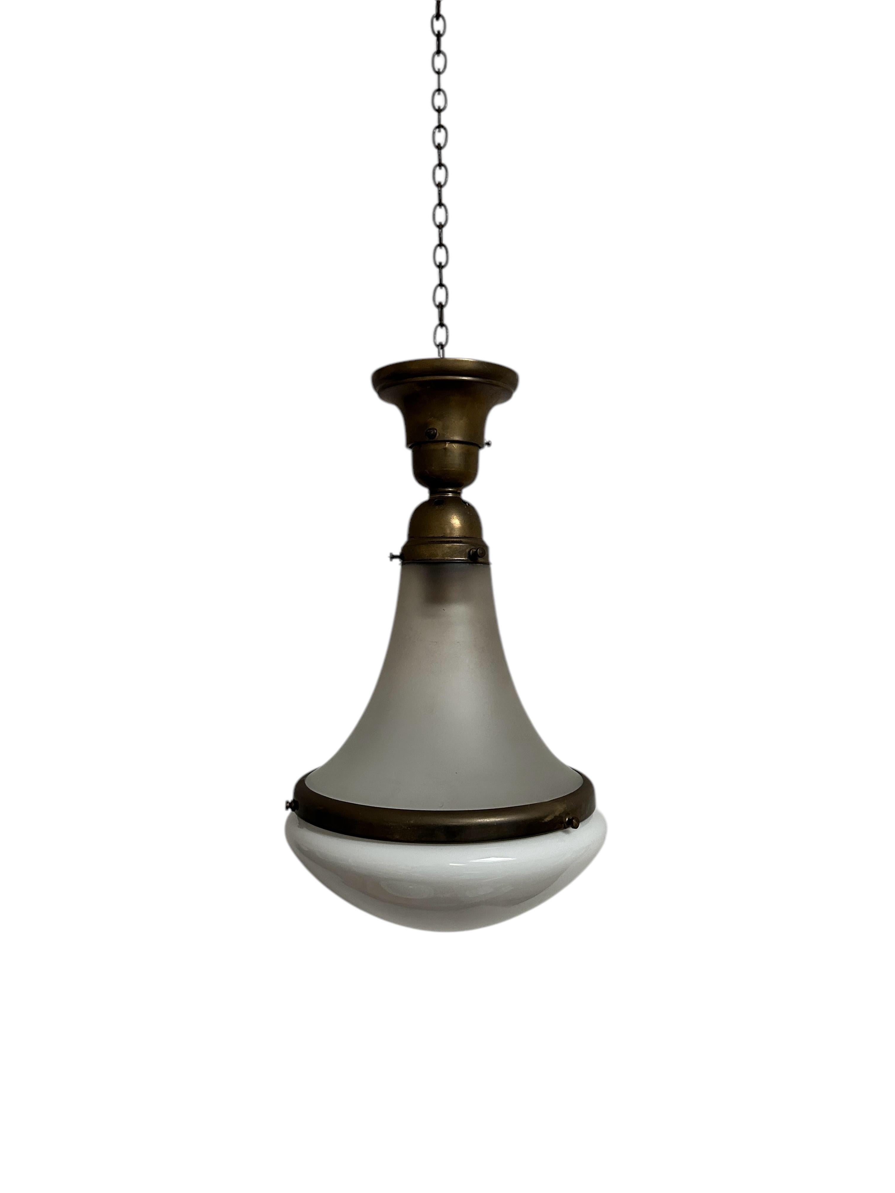 - An original and rare Bauhaus ceiling pendant by AEG, Germany circa 1920.
- The pendant consists of a fluted frosted glass body and separate opaline dish, held together by a decorative brass band and bronze gallery. 
- Beautiful unusual design and