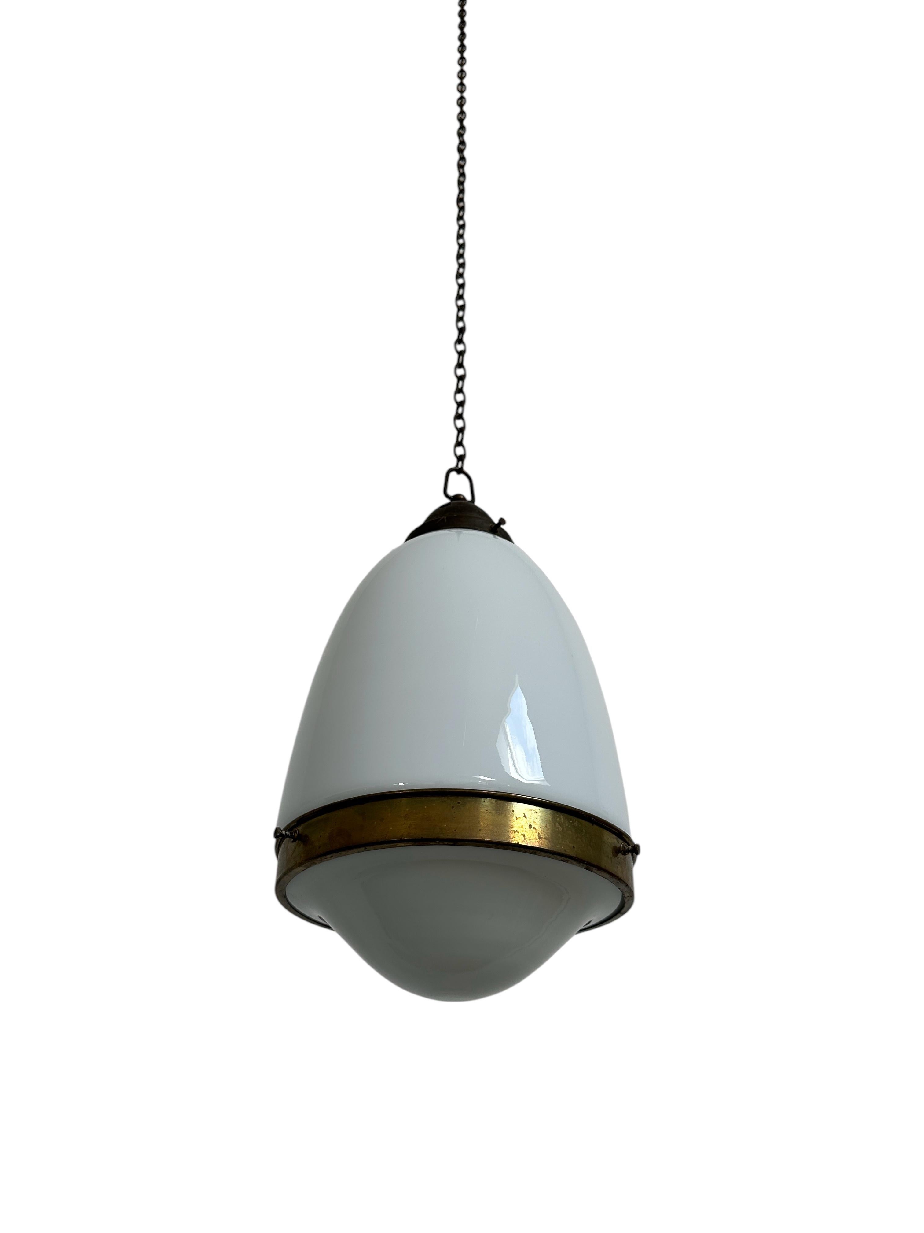 - An original and rare Bauhaus opaline brass ceiling pendant, Germany circa 1930.
- The pendant consists of an opaline shaped body and lower dish, held together by a decorative brass band. 
- Beautiful unusual design reminiscent of Peter Behrens and