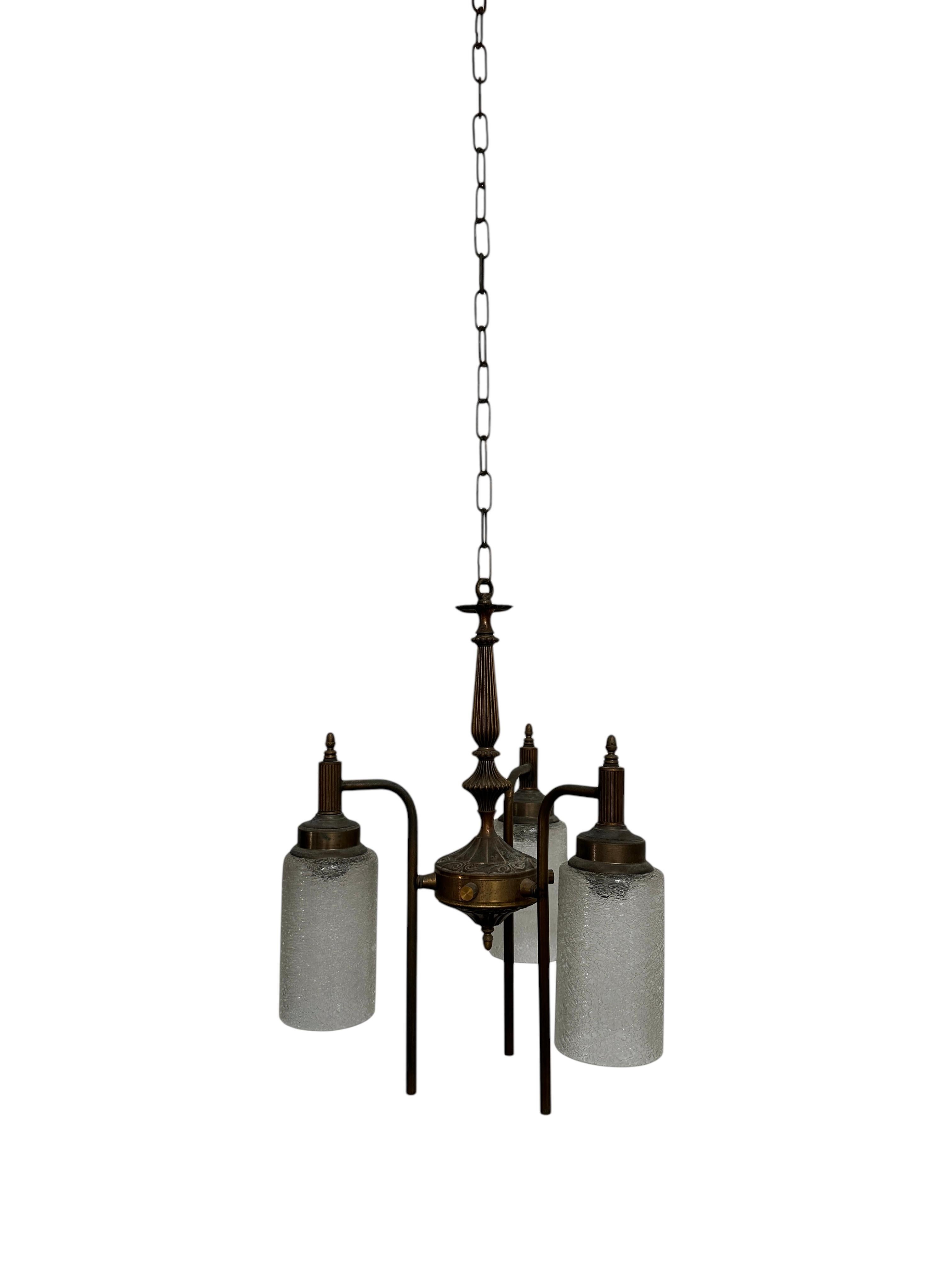 - An exquisite three-arm bronze ceiling chandelier featuring high-quality glasswork, Germany circa 1920.
- The fixture comprises of three arched decorative arms each encompassing an etched glass shade, the central column ribbed with detail