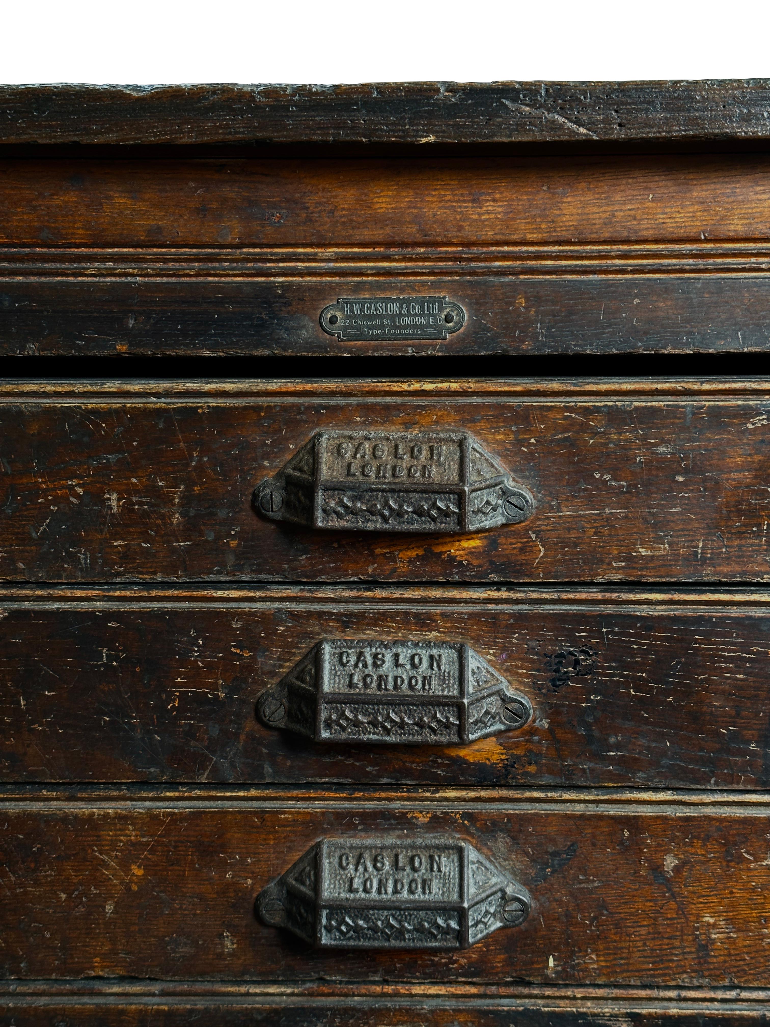 - A wonderful bank of industrial printers drawers by Caslon London, English circa 1920.
- There are 8 well worn graduated drawers in total all showing fine grain interest and rich amber hues.
- The drawers retain their original makers label marked