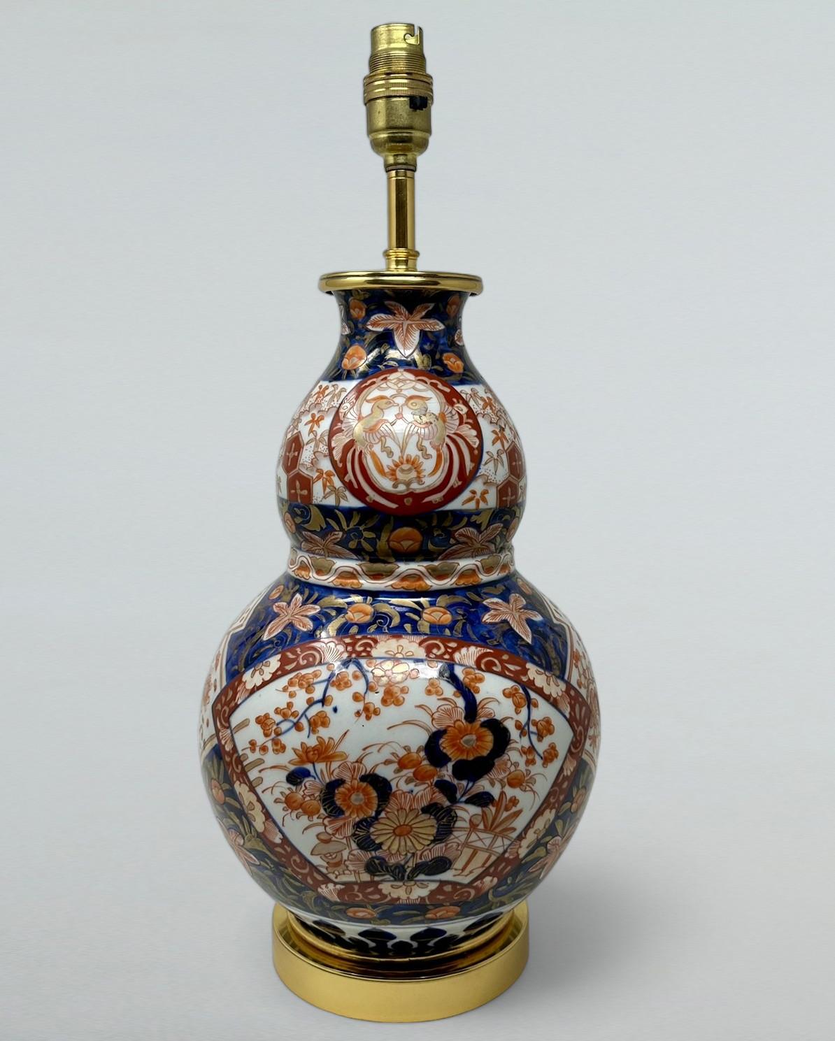 Stunning Traditional Japanese Imari hand decorated Porcelain Vase of seldom seen double gourd form glazed porcelain, of generous proportions, now converted to an Electric Table Lamp, complete with later plain heavy-duty Ormolu circular stepped base.