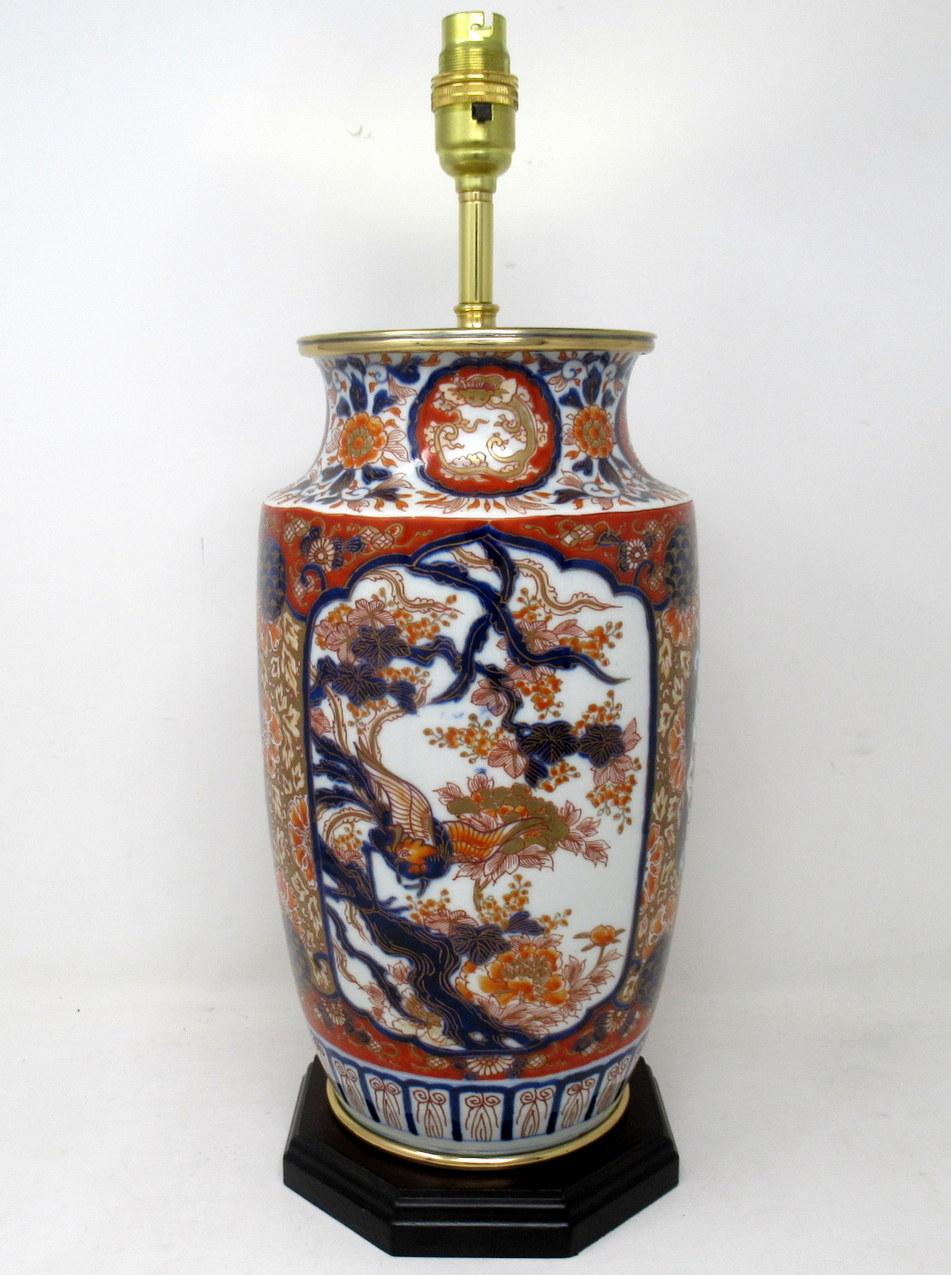 Stunning Traditional Japanese Imari hand decorated porcelain baluster form glazed porcelain Vase of good-sized proportions, now converted to an electric Table Lamp, complete with later plain heavy-duty Ormolu circular mount and ebonized wooden