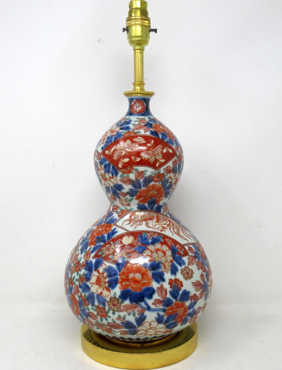 Stunning Traditional Japanese Imari hand decorated Porcelain of seldom seen double gourd form glazed porcelain, of generous proportions, now converted to an electric table lamp, complete with later plain heavy-duty Ormolu circular stepped base.