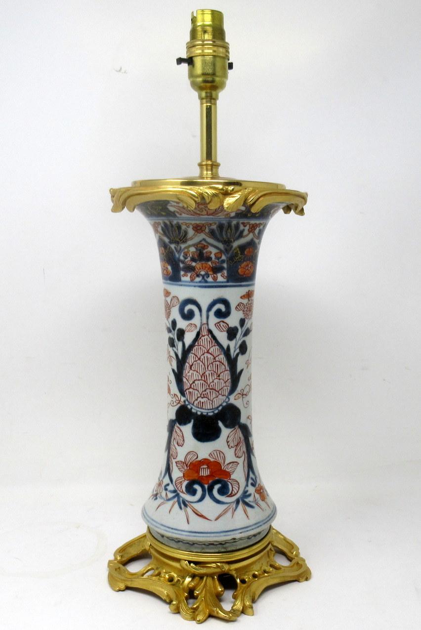 An imposing and stunning single traditional Japanese Imari waisted form hand painted porcelain vase of tall slender proportions. First half of the Eighteenth century, Edo Period. 

The main outer porcelain body with stylish flared rim mounted with
