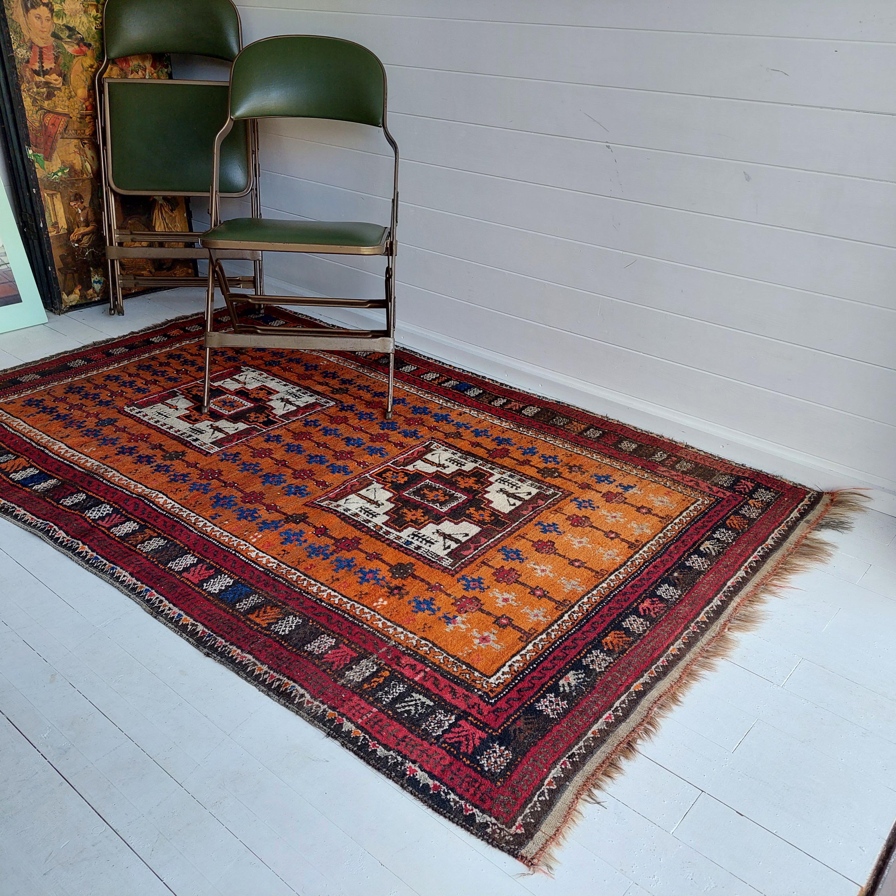 A good example of Caucasian Karachov Kazak handwoven rug
With the traditional medaillon design, on a scare orange ground.
The colour combinations make this a visually striking rug.
Note the many tribal filler items in the field. The main border is