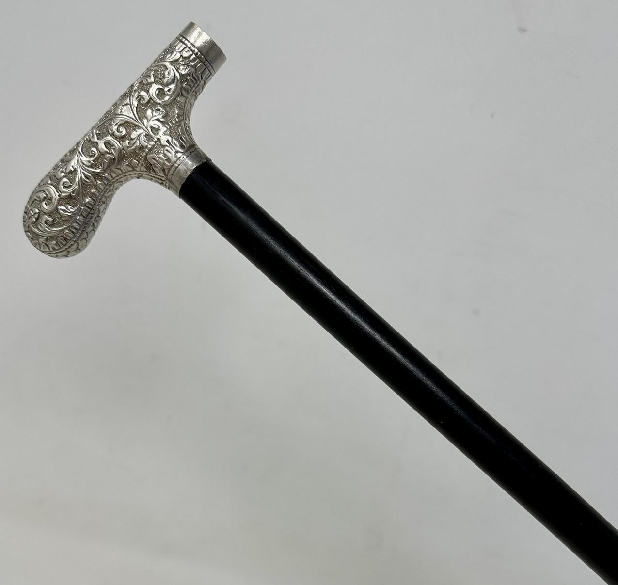 Stylish Solid Polished Ebonised Wood and Sterling Silver Lady’s Walking Stick Dress Cane with Traditional ornately cast Tau shaped handle in Art Nouveau style, of French or English origin, complete with its original bi-metal polished ferrule, which