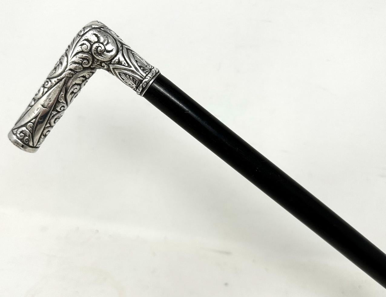 An absolutely stunning Lady's or Gentleman's Walking Cane of English origin and of exceptional quality. Manufactured and retailed by the famous Store James Smith & Sons located in Oxford Street, London. 

The ornate “L” shaped Sterling silver handle