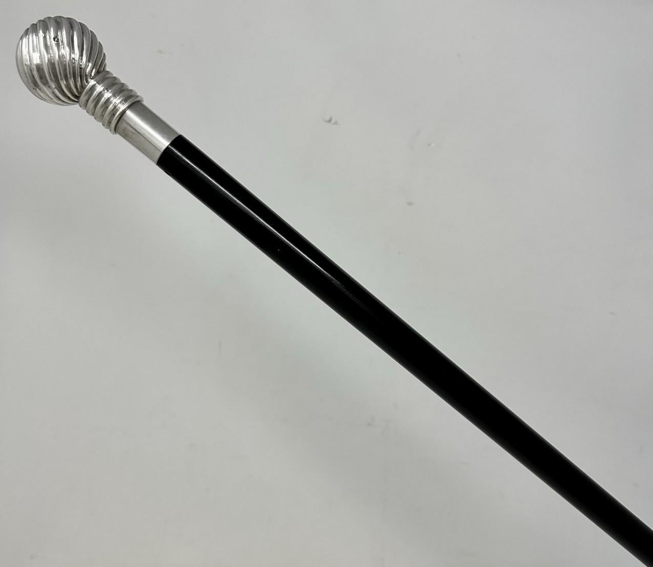 Fine Quality Ebony Lady’s or Gentleman’s Walking or Dress Cane with unusual plain and reeded Banded decorative Silver Pommel, early Twentieth Century, of Continental origin. 

The decorative swirling silver knopped ball grip above a tapering ebony