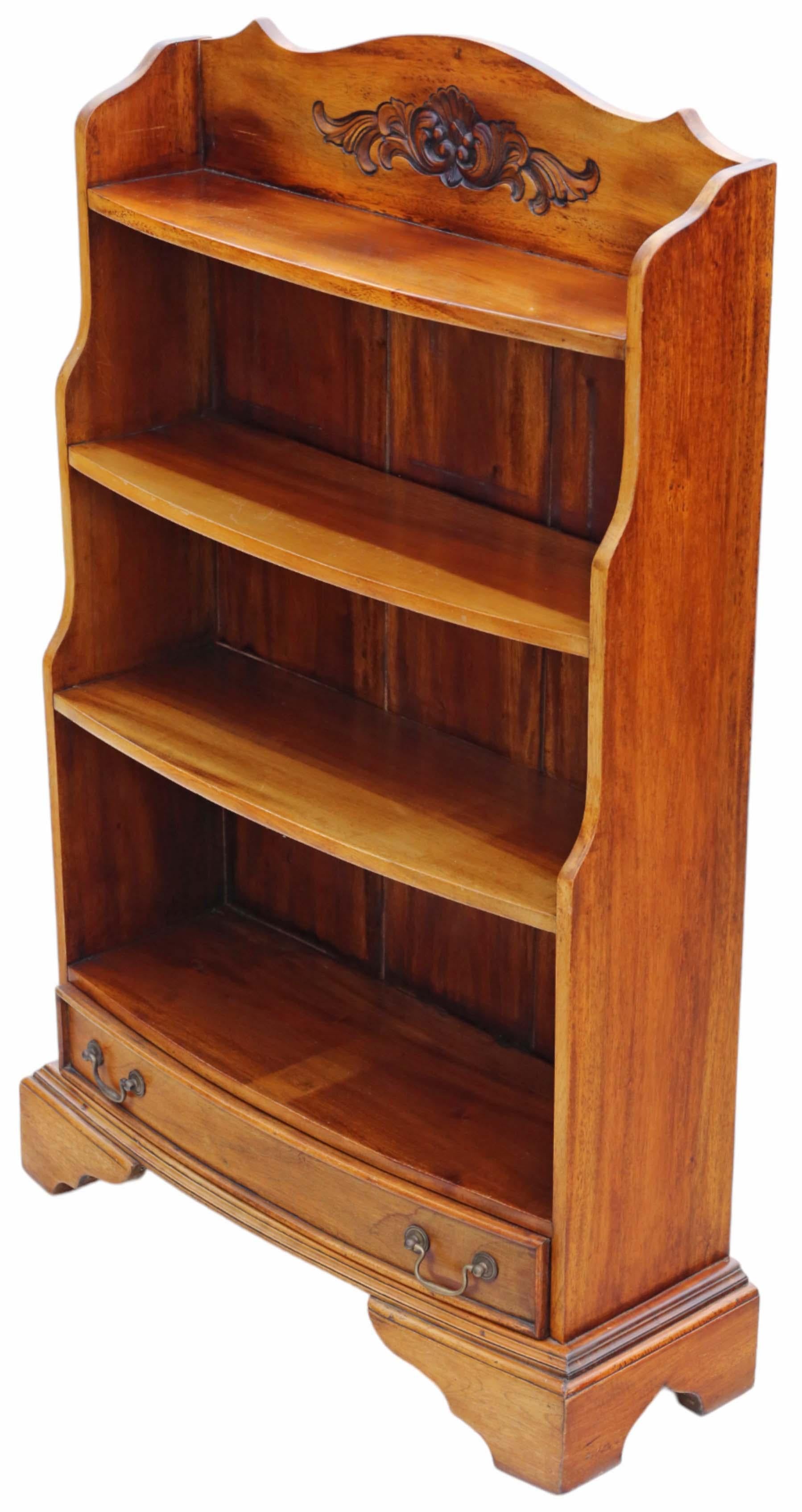 Antique vintage late 20th Century large mahogany waterfall bookcase.

Solid, with no loose joints and no woodworm. The drawer slides freely.

Overall maximum dimensions: 71cmW x 26cmD x 107cmH.

Shelves:

Bottom 62cm wide x 22cm deep x 25cm high