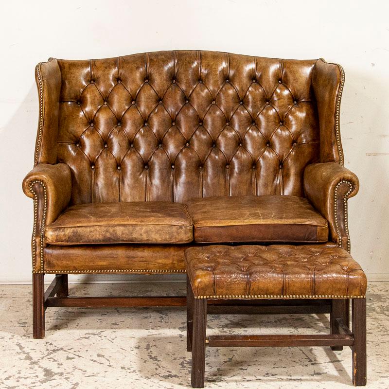 It is the rich caramel color of the vintage leather that captures your attention in this wonderful set. This large wingback Chesterfield loveseat or 