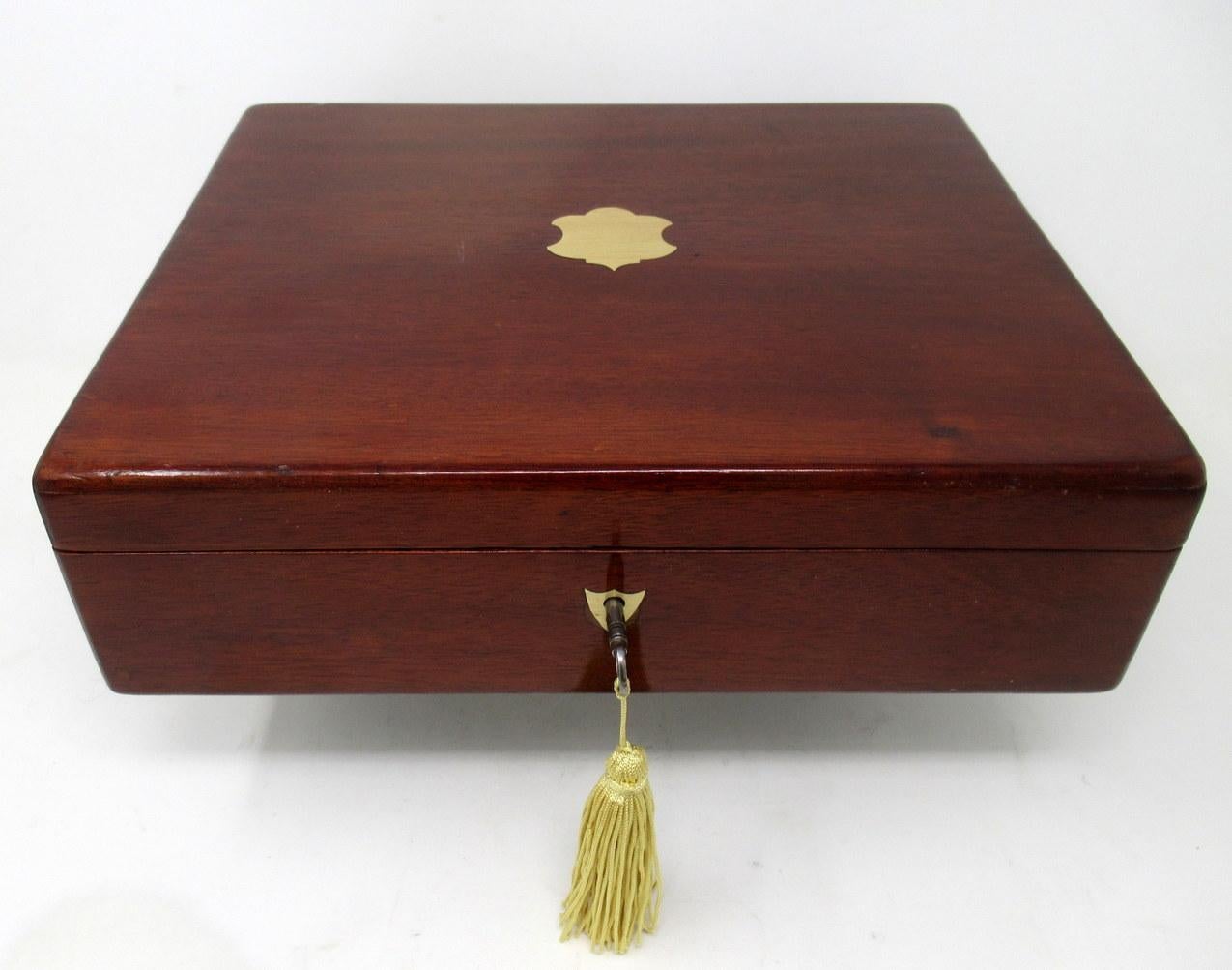 An Exceptionally Fine Quality English Well Figured Solid Mahogany Ladies or Gents Jewelry or Storage Box of outstanding quality and medium proportions, with decorative vacant initial plate to outer lid, flush hinges and polished brass shield form