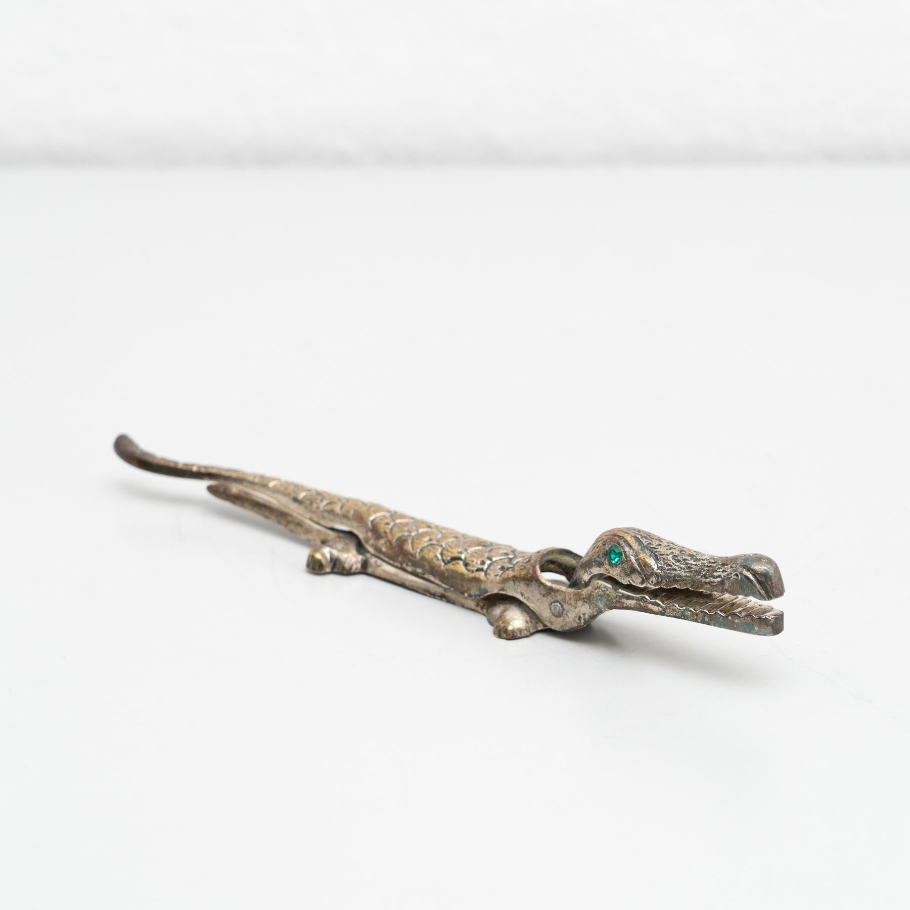 Antique vintage traditional nutcracker. In a crocodile shape.

Made by unknown manufacturer in France, circa 1960.

In original condition, wear consistent with age and use, preserving a beautiful patina.

Materials:
Metal.
 
