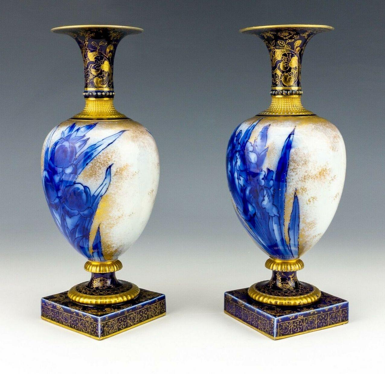 Stylish identical pair of English porcelain mantle vases by Famous English pottery maker Royal Doulton Burslem, late 19th century.

Each ovoid central body superbly decorated with flo-blue Iris flowers on an off-white ground, the back with similar