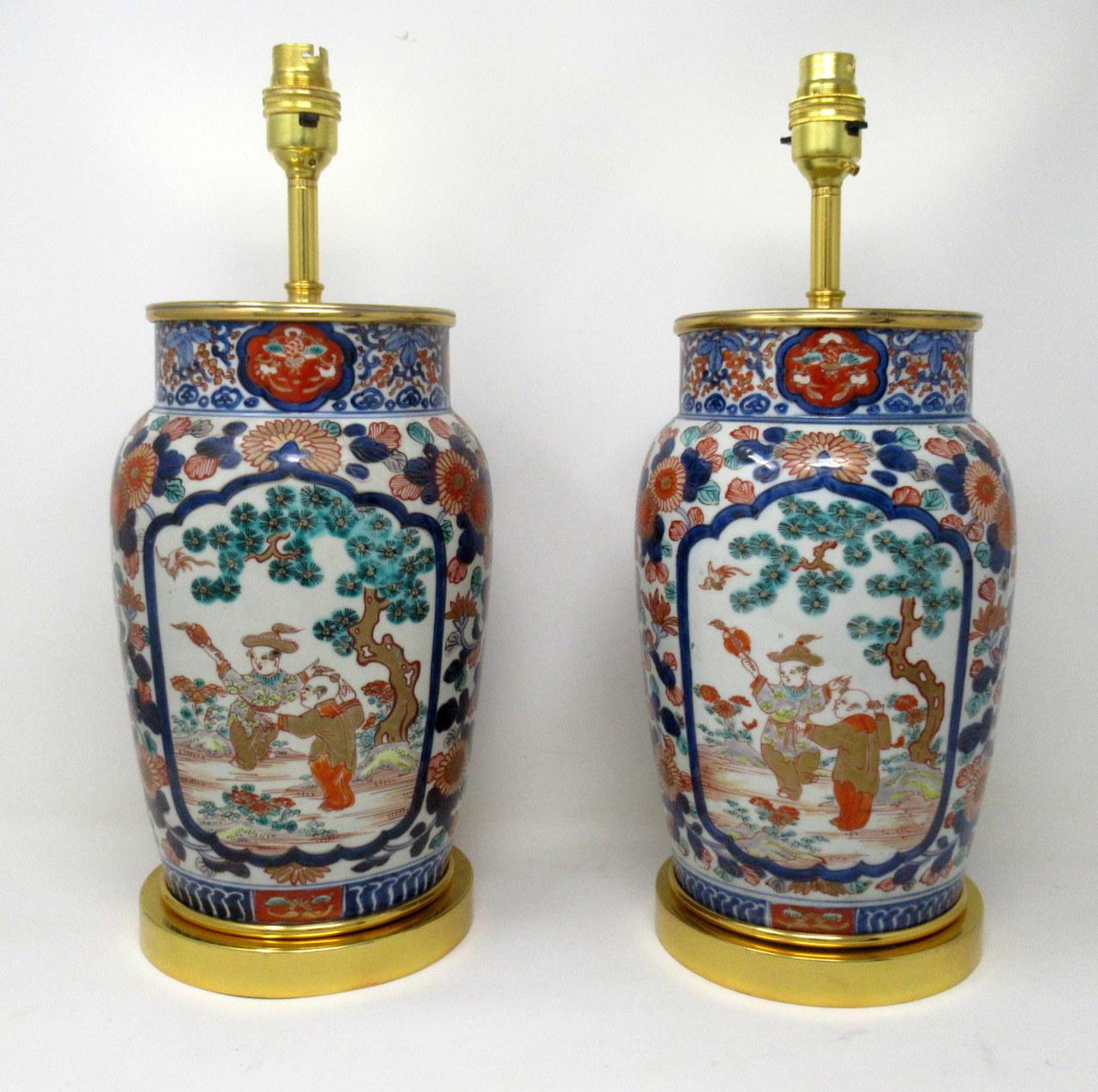 Stunning pair of Traditional Japanese Imari Bulbous form porcelain vases of generous proportions, now converted to a pair of electric table lamps, complete with their later Ormolu stepped bases and mounts, first half of the 19th century.

The main