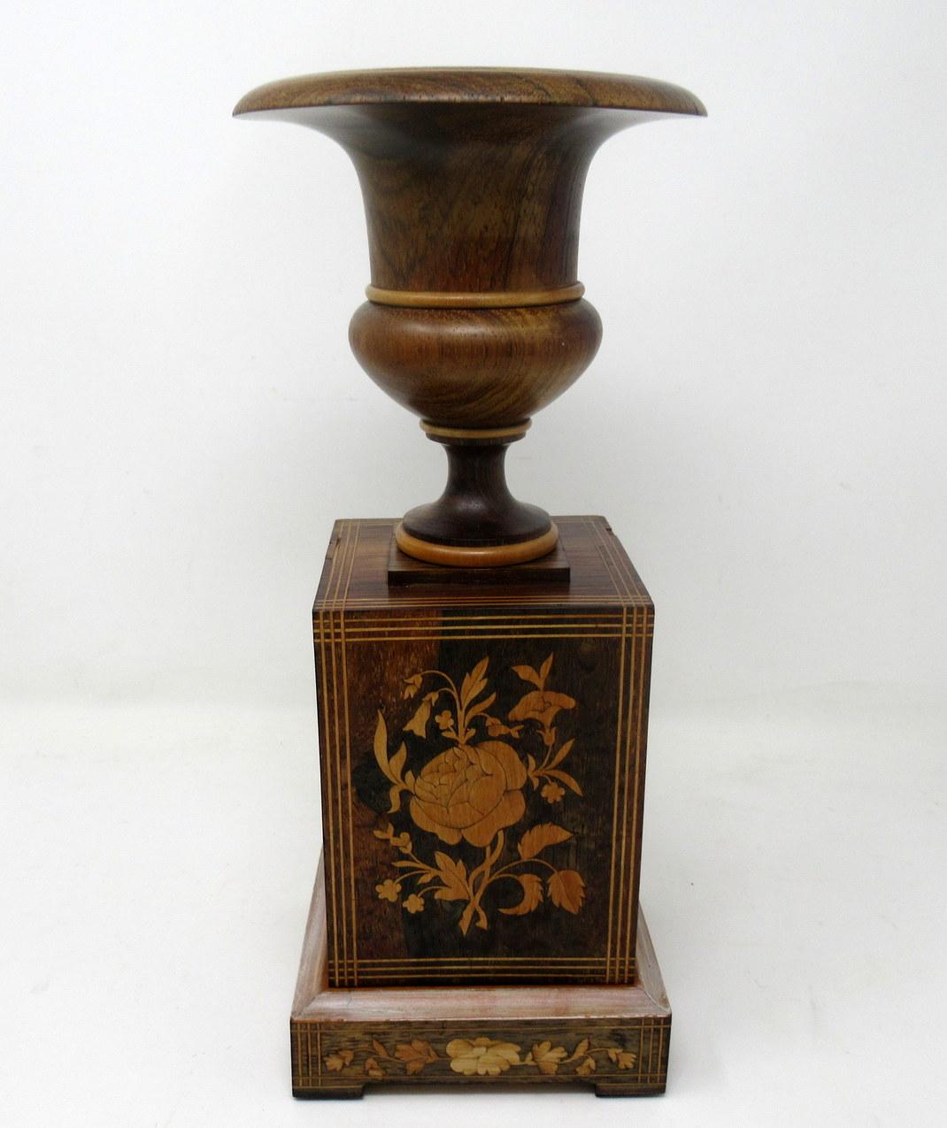 An exceptionally fine quality & quite rare pair of well figured solid rosewood decorative candlestick urns of generous proportions and of english origin. Circa 1950s.

Each of traditional Campana form on generous square plinths ending on stepped