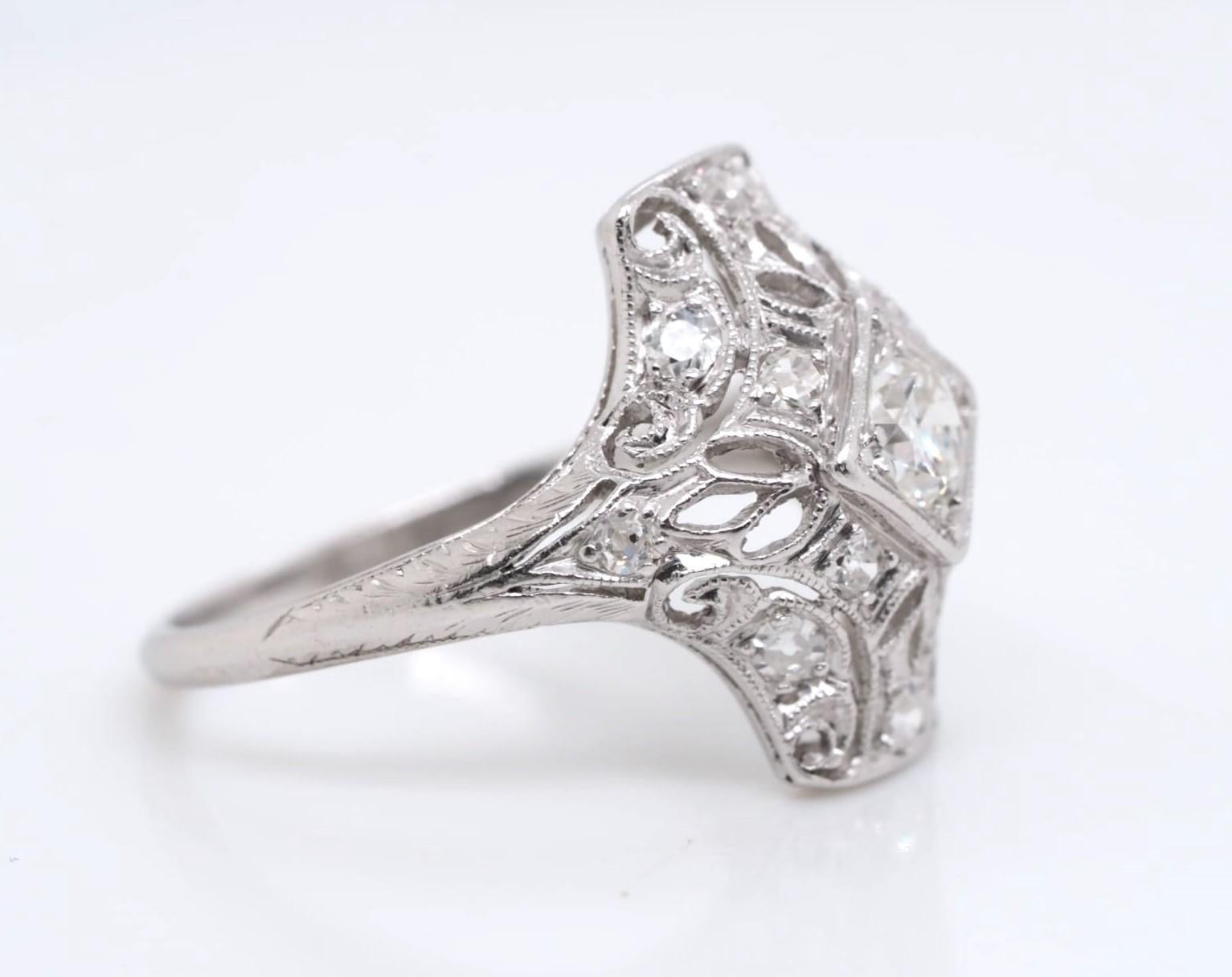 This vintage and antique engagement ring is made of genuine platinum and features a stunning 0.5 ct old European cut diamond. The ring is size 4.5 and can be resized if needed. The diamond has a very slight inclusion (VS2) and has a color grade of