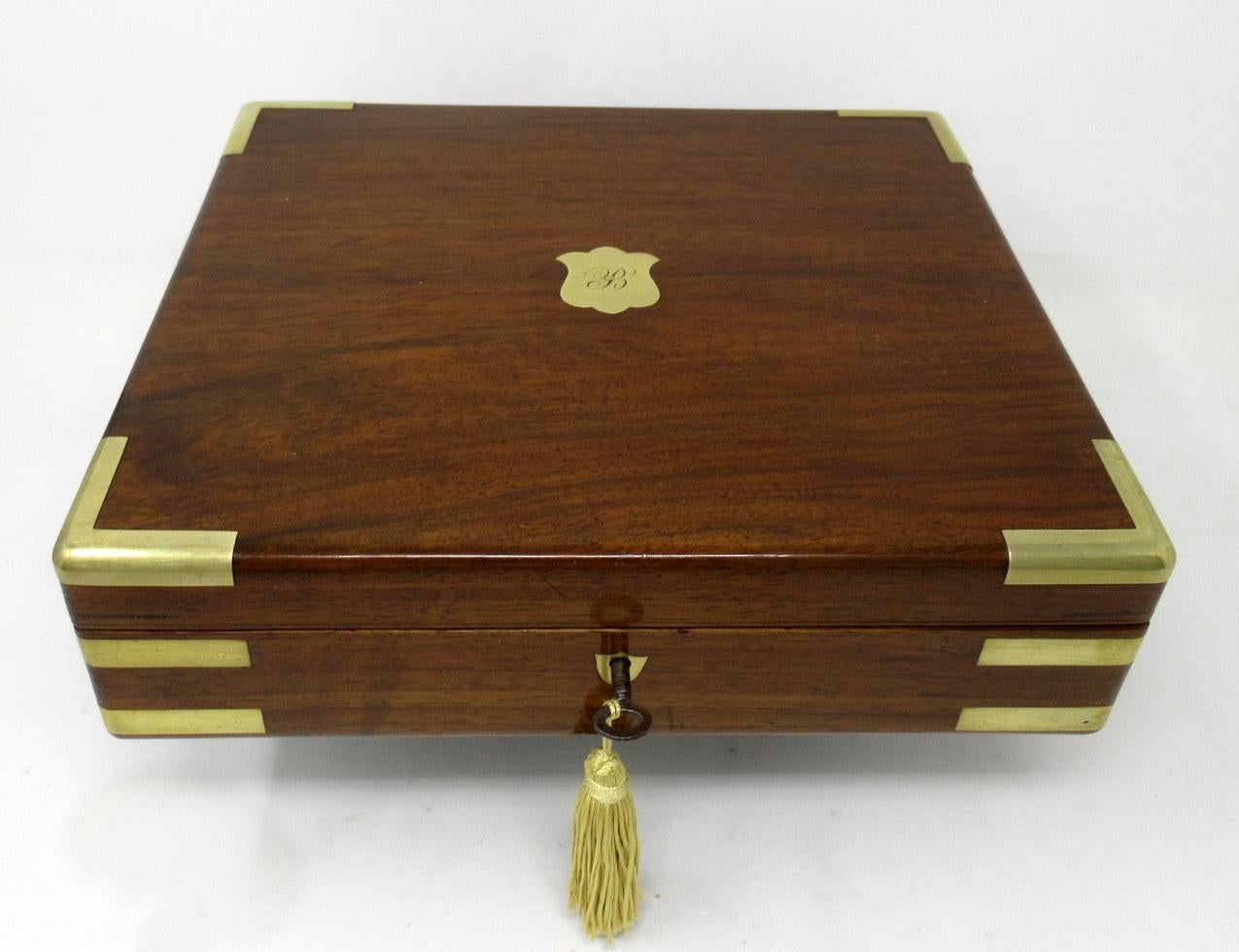 An exceptionally fine quality English well figured solid mahogany ladies or gents jewelry or storage box outstanding quality and medium proportions, with unusual moulded brass inlay decoration, flush hinges and polished brass shield form escutcheon,