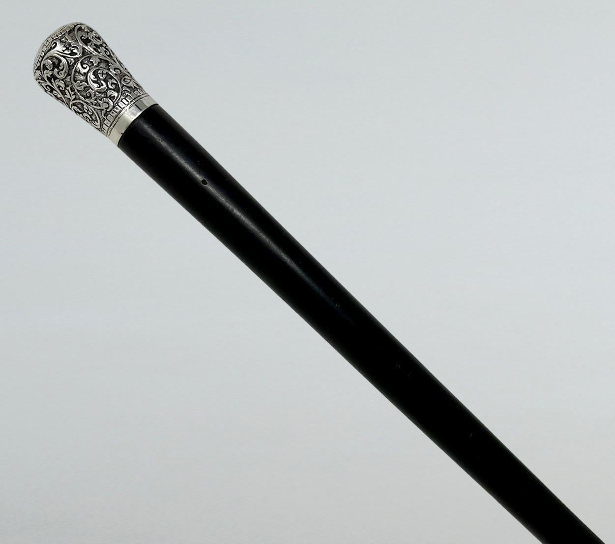 Fine Quality Chinese Polished Heavy Gauge Ebony Walking Cane Stick with Highly Decorative Embossed Silver Grip, made in China during the last quarter of the Nineteenth Century.  

The circular silver beautifully embossed knopped silver grip above a