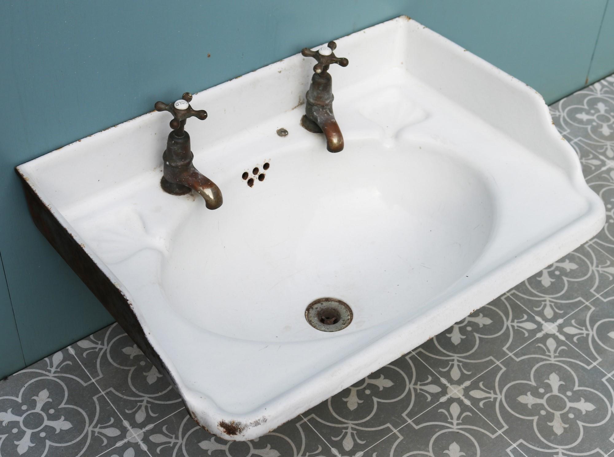 An unusual reclaimed cast iron sink with original brass taps.