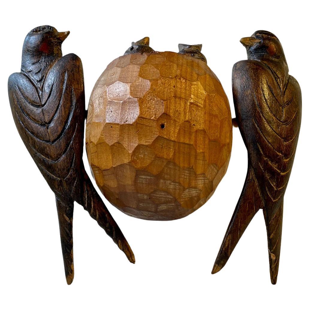 A handmade piece of Scandinavian Volk/Folk art. It depicts a pair of nesting swallows executed in diffrent types of wood and is meant for wall mounting. Measurements: 17x18x6 cm.