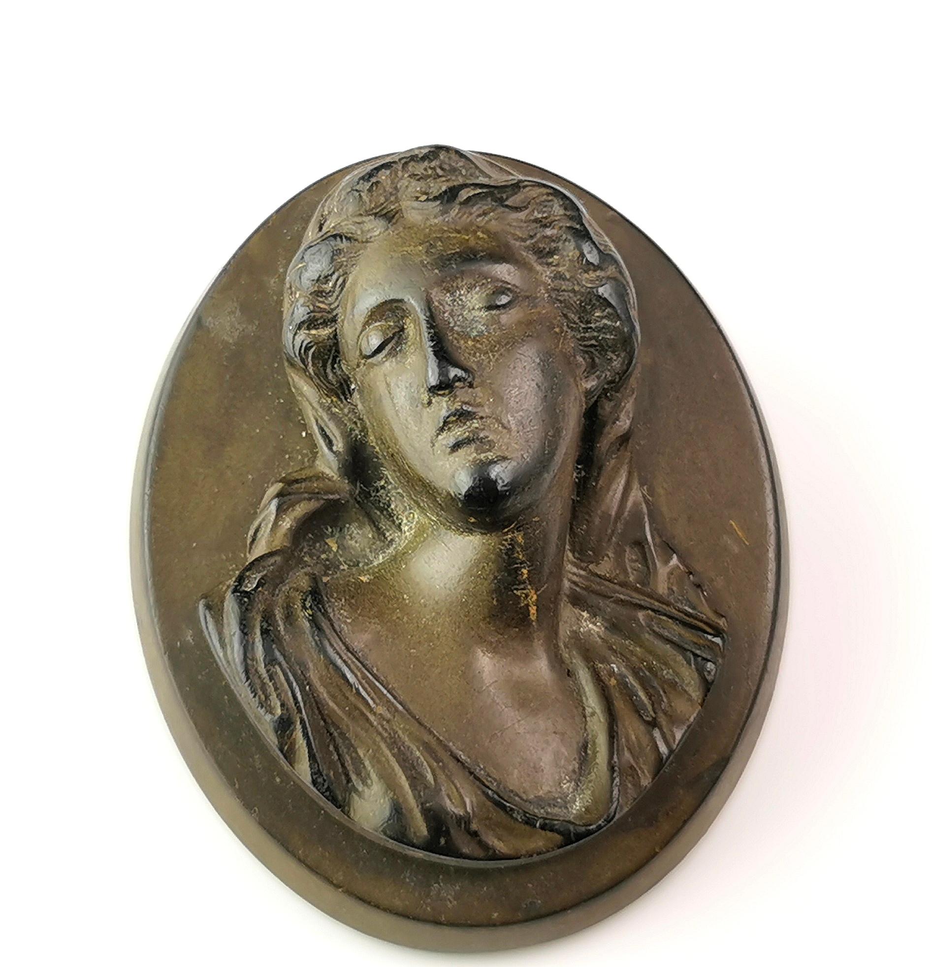 An interesting antique Victorian era Vulcanite cameo brooch.

It is a very well designed piece depicting a lady, possibly Mary.

The cameo has some lightening to the Vulcanite but no chips or cracks and is a nice unusual design.

Vulcanite was