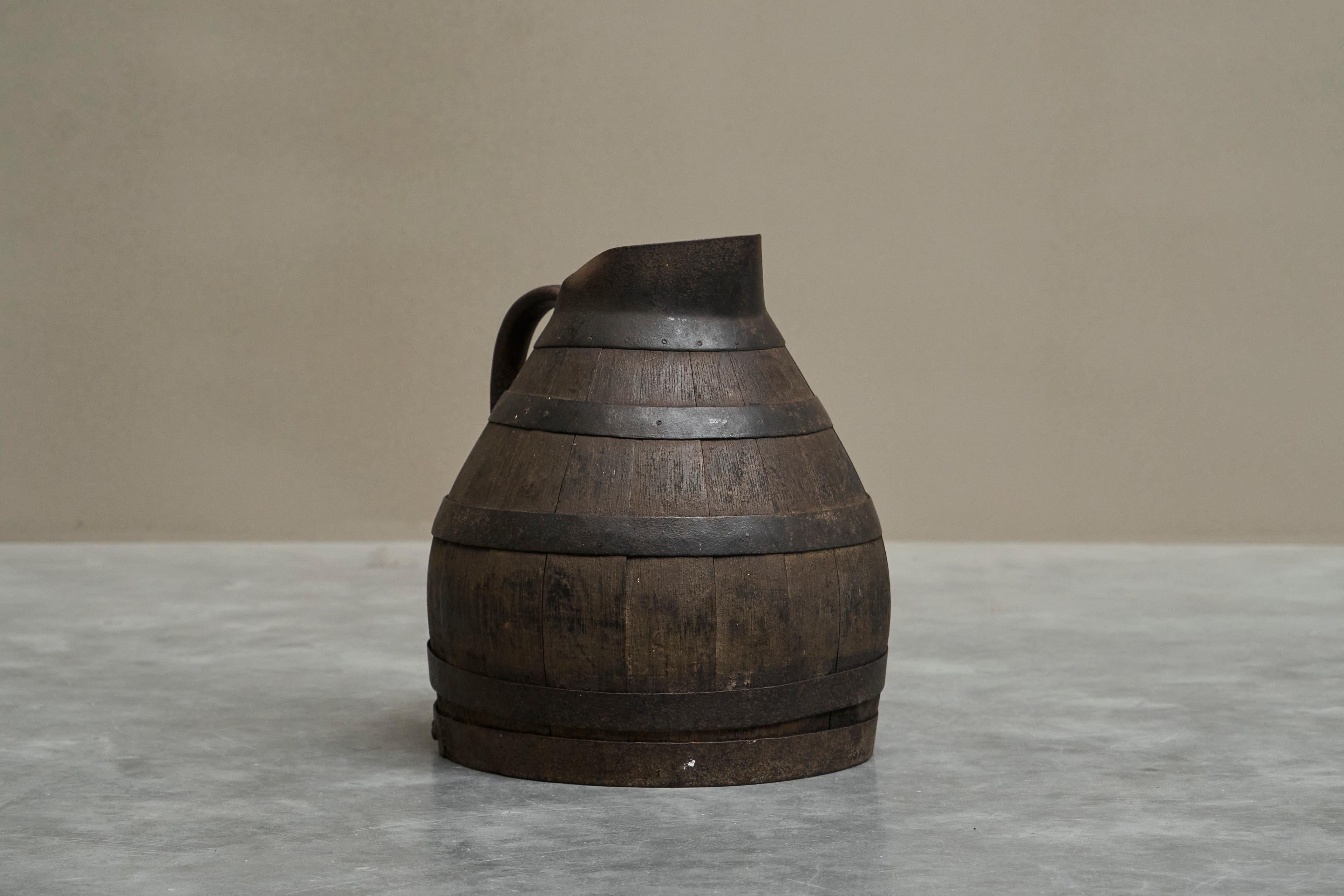 Antique Wabi Sabi Barrel Jug in Wood and Wrought Iron.

Wonderful and fairly large early to mid 19th century barrel jug in wood and wrought iron. Great design - very well proportioned. Wonderful details like the sprout, the way the handle is