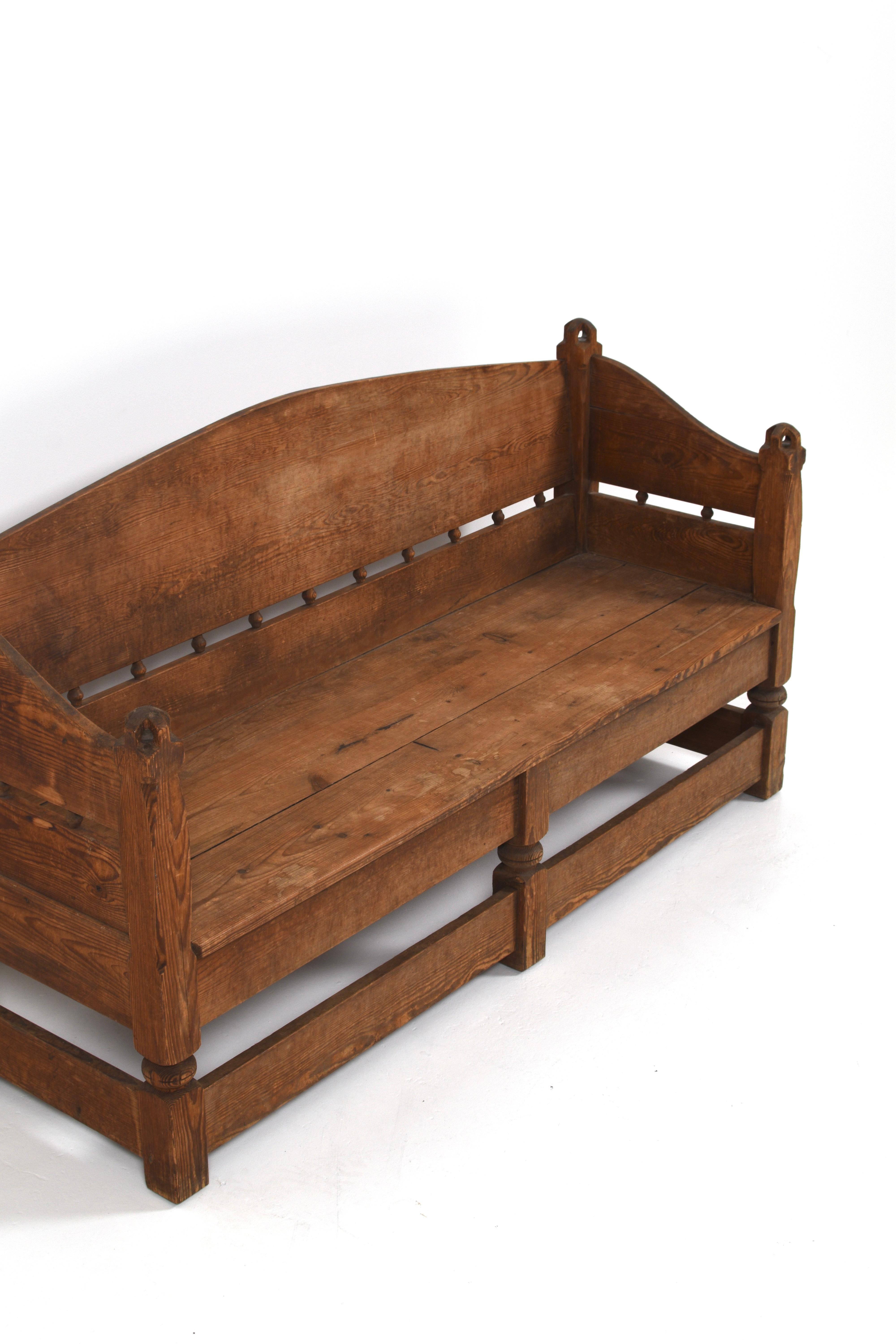 This antique Wabi-Sabi church bench in pine exudes a timeless charm, embodying the essence of Wabi-Sabi philosophy - the acceptance of imperfection. Crafted from pine, this bench carries the marks of age and wear, adding character and authenticity