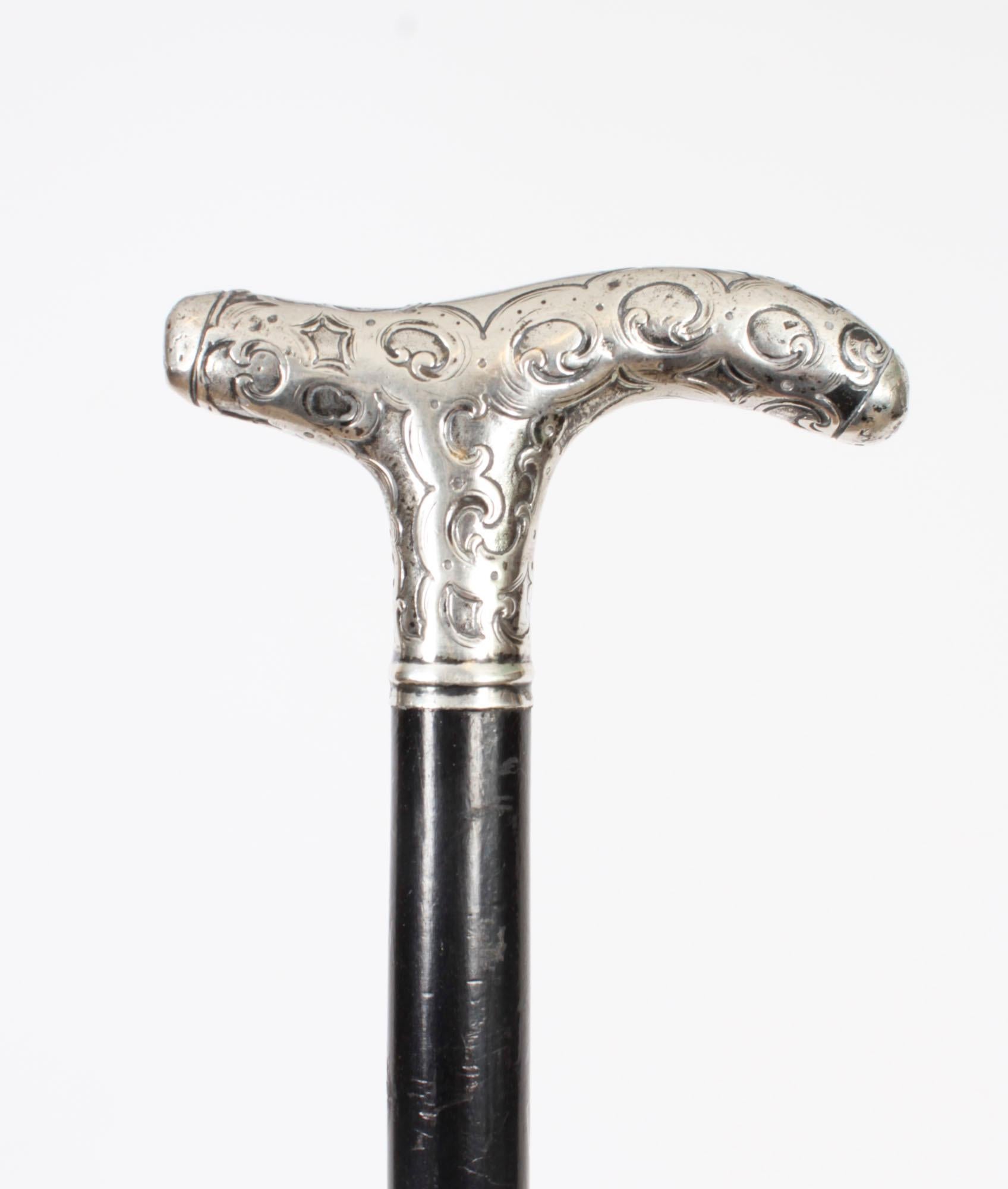 This is a beautiful continental antique sterling silver pommel walking stick, marked 800 on the sleeve, circa 1890 in date
 
The striking stick features an ornate silver crutch handle that has a profusely embossed star and swirl design, on a gentle