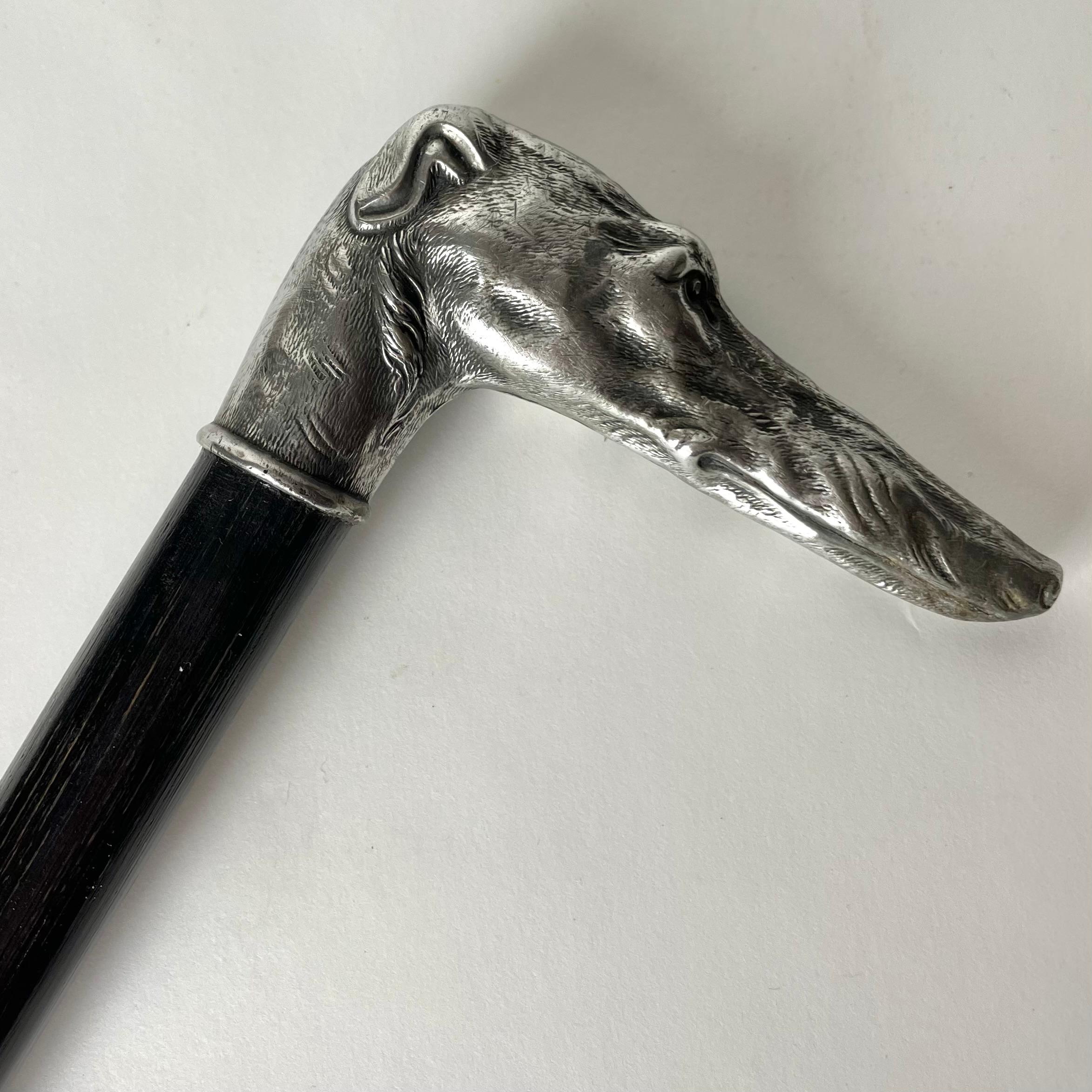 
A charming walking cane/stick from the late 19th century with a Greyhound head handle. The stick is wooden and with a white metal handle.

Wear consistent with age and use.