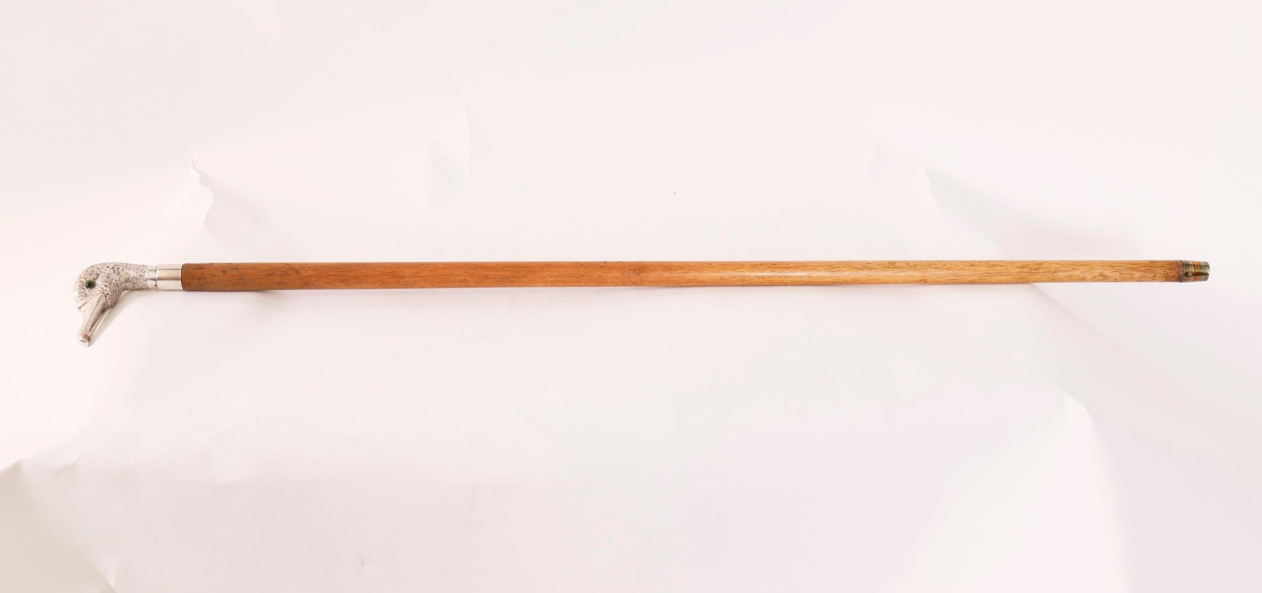 This is a beautiful Antique English sterling silver duck head handle walking stick bearing  hallmarks for London 1909.

This charming walking cane features a finely cast sterling silver duck head handle with green glass eyes on a hardwood cane.

The
