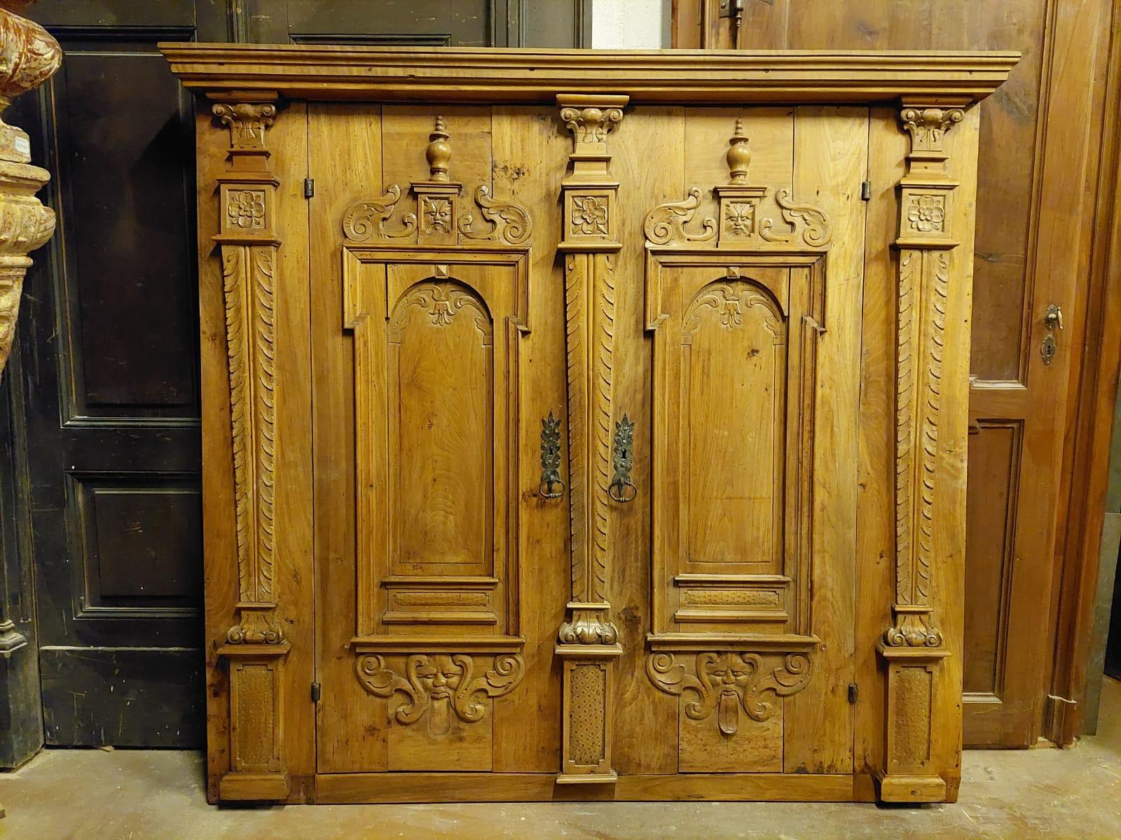 Ancient wall cabinet, richly carved by hand, in precious walnut wood, built for a rustic house in Valle d'Aosta (Northern Italy) in the 18th century, maximum size (from the hat) cm W 187 x H 174, central body w 180, the two doors open by pulling and