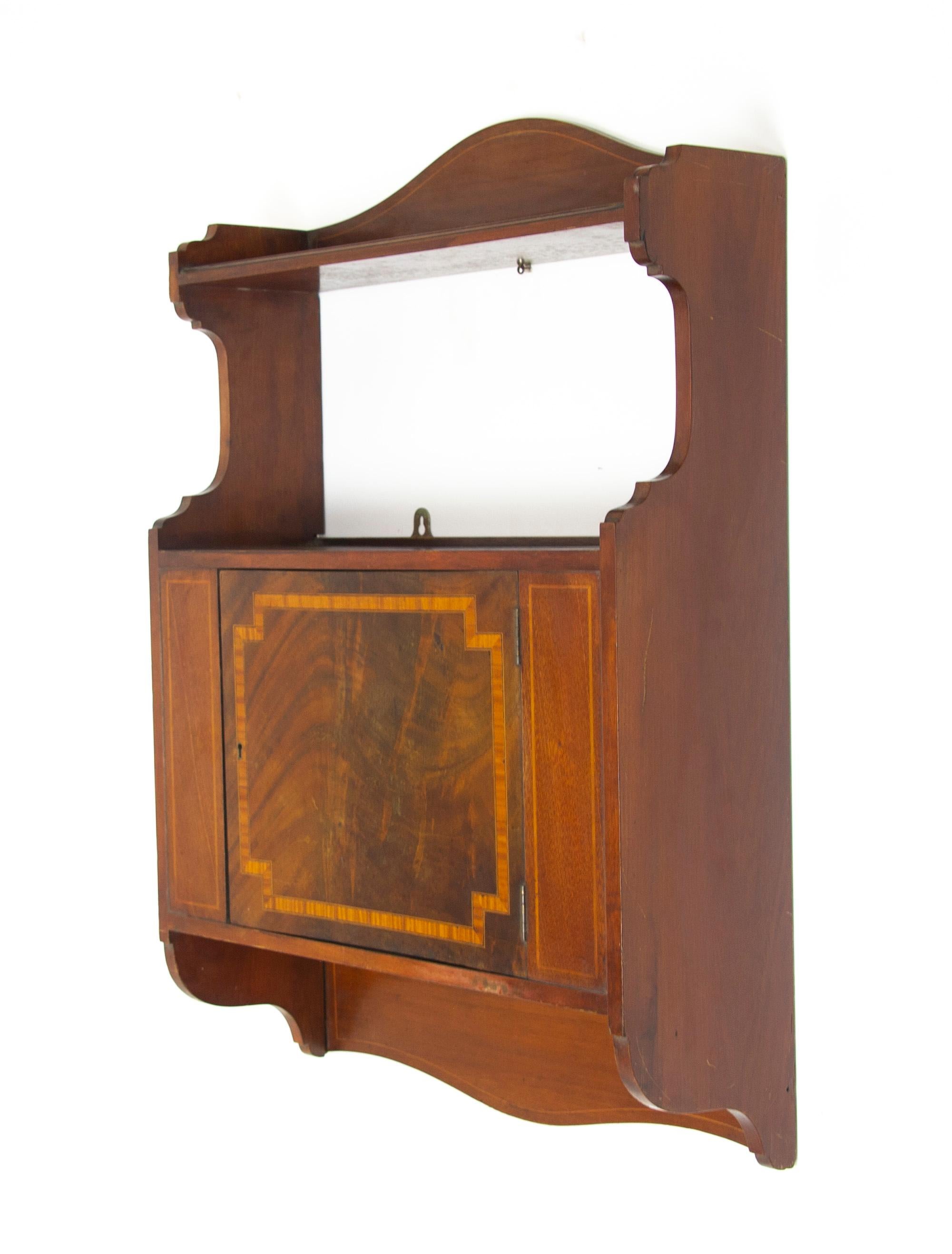 Antique wall cabinet, Scottish Iinlaid walnut hanging wall cabinet, antique furniture, Scotland 1910, B1369

Scotland 1910
Solid walnut and veneers
Original finish
Shaped back with single shelf below
Inlaid front sides
Single inlaid