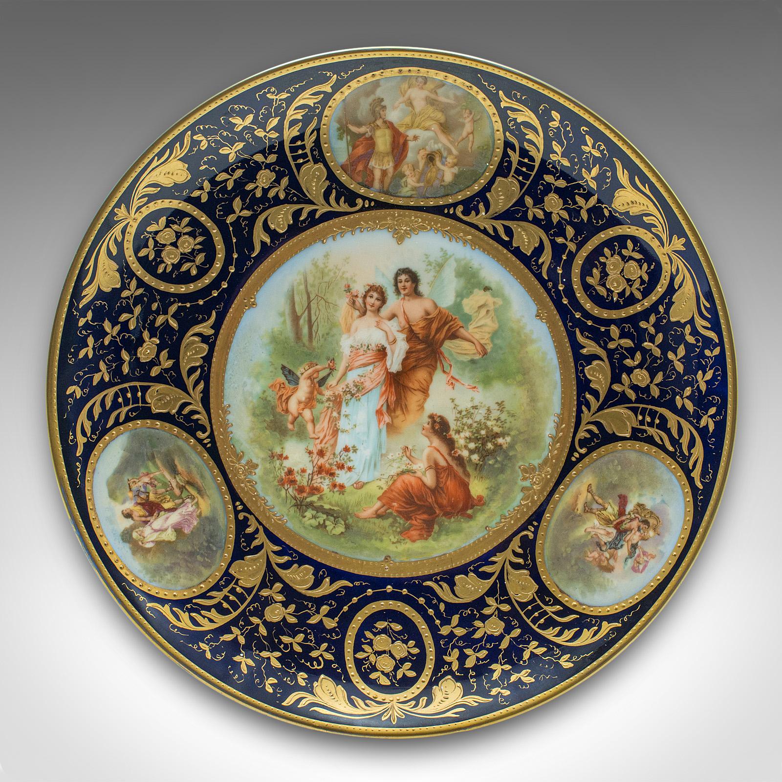 
This is an antique wall charger. An Austrian, gilt ceramic decorative plate, dating to the late Victorian period, circa 1900.

Striking classical theme and eye-catching finishes to this fine Vienna plate
Displays a desirable aged patina and in good