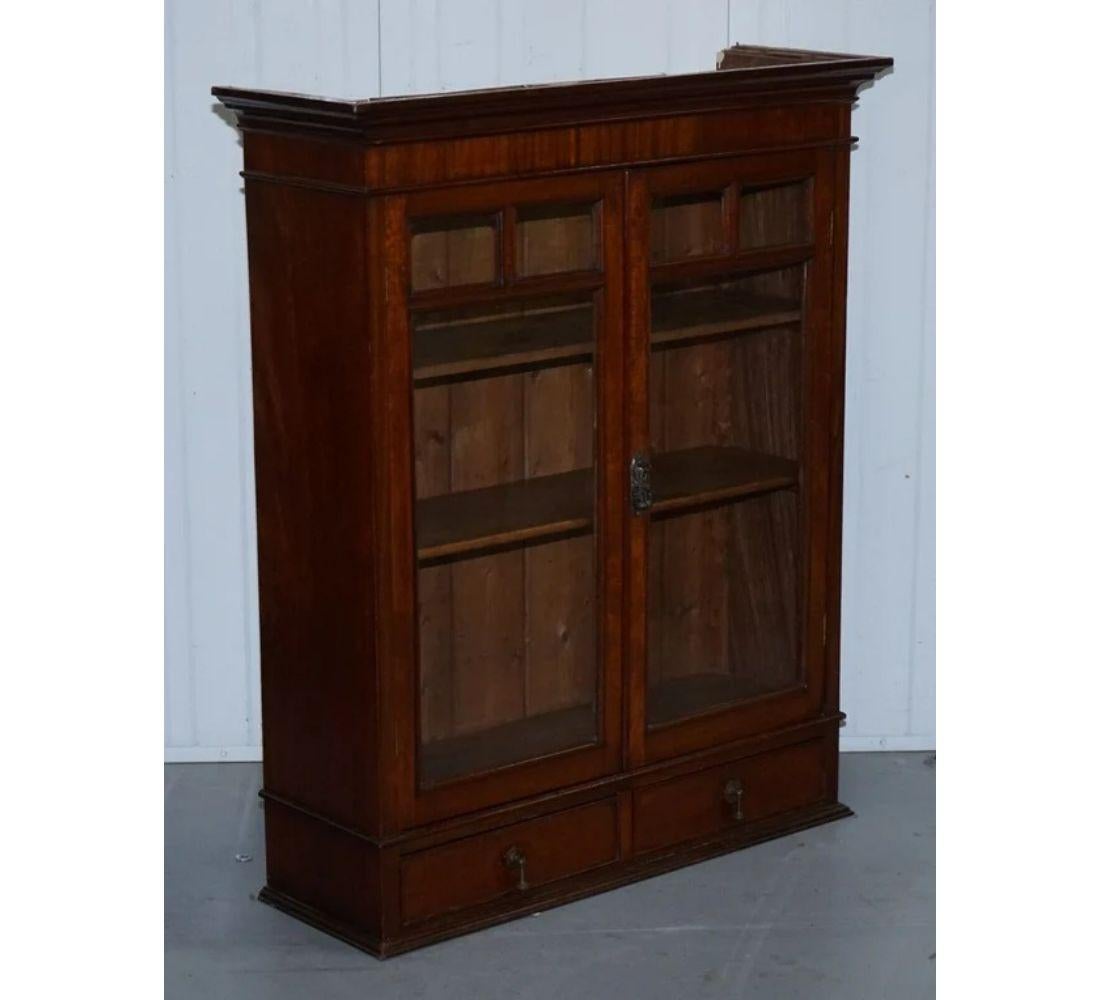 We are delighted to offer for sale this Antique wall kitchen cabinet or bookcase with Glazed doors.

It has some signs of wear, as you would find with any antique piece, but the wear gives it its unique look. We have lightly restored this by